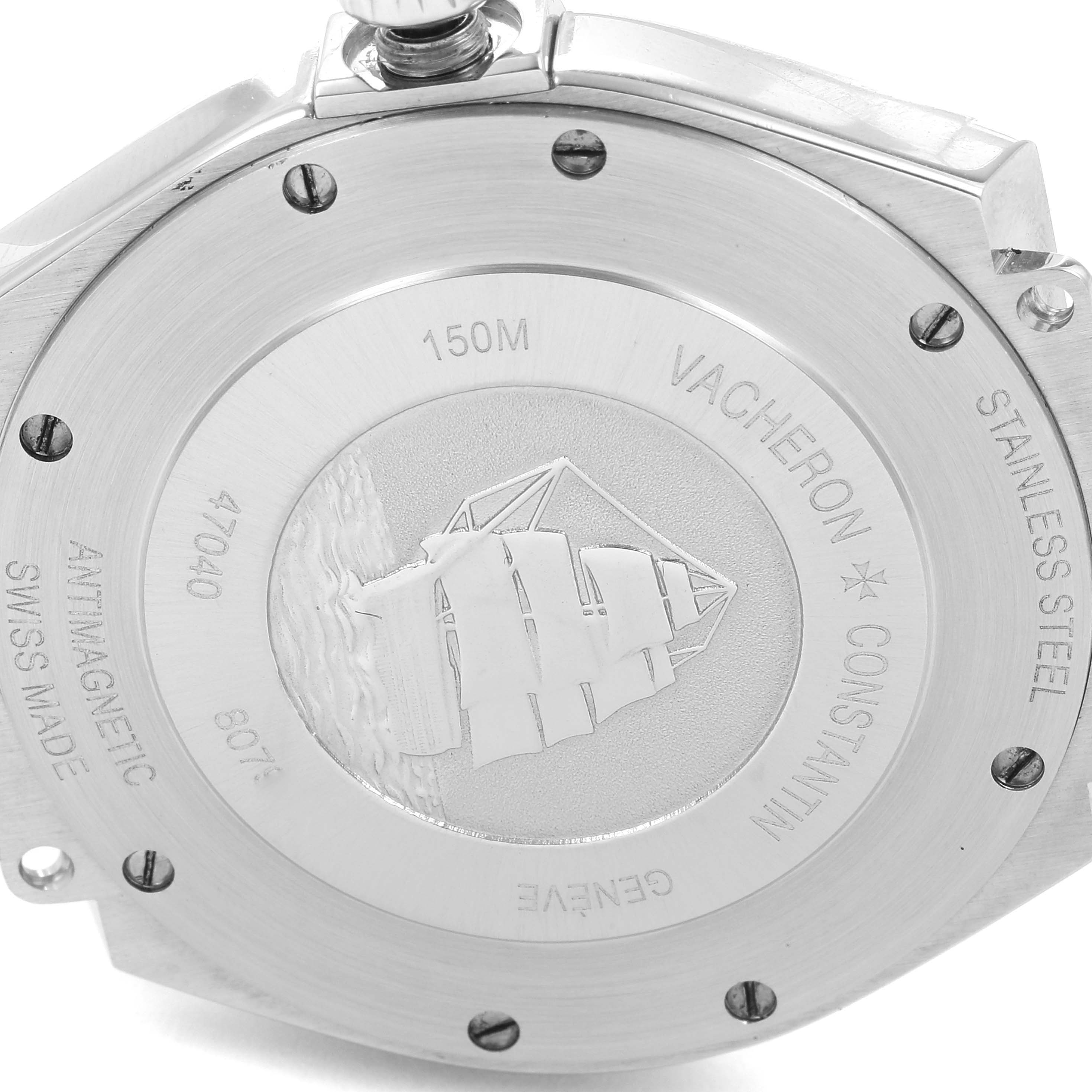 The image shows the back of the Vacheron Constantin Overseas 47040B01A-9093 Men's Stainless Steel Silver Dial 47040B01A-9093 Men's Stainless Steel Silver Dial watch, highlighting its stainless steel case and engravings.