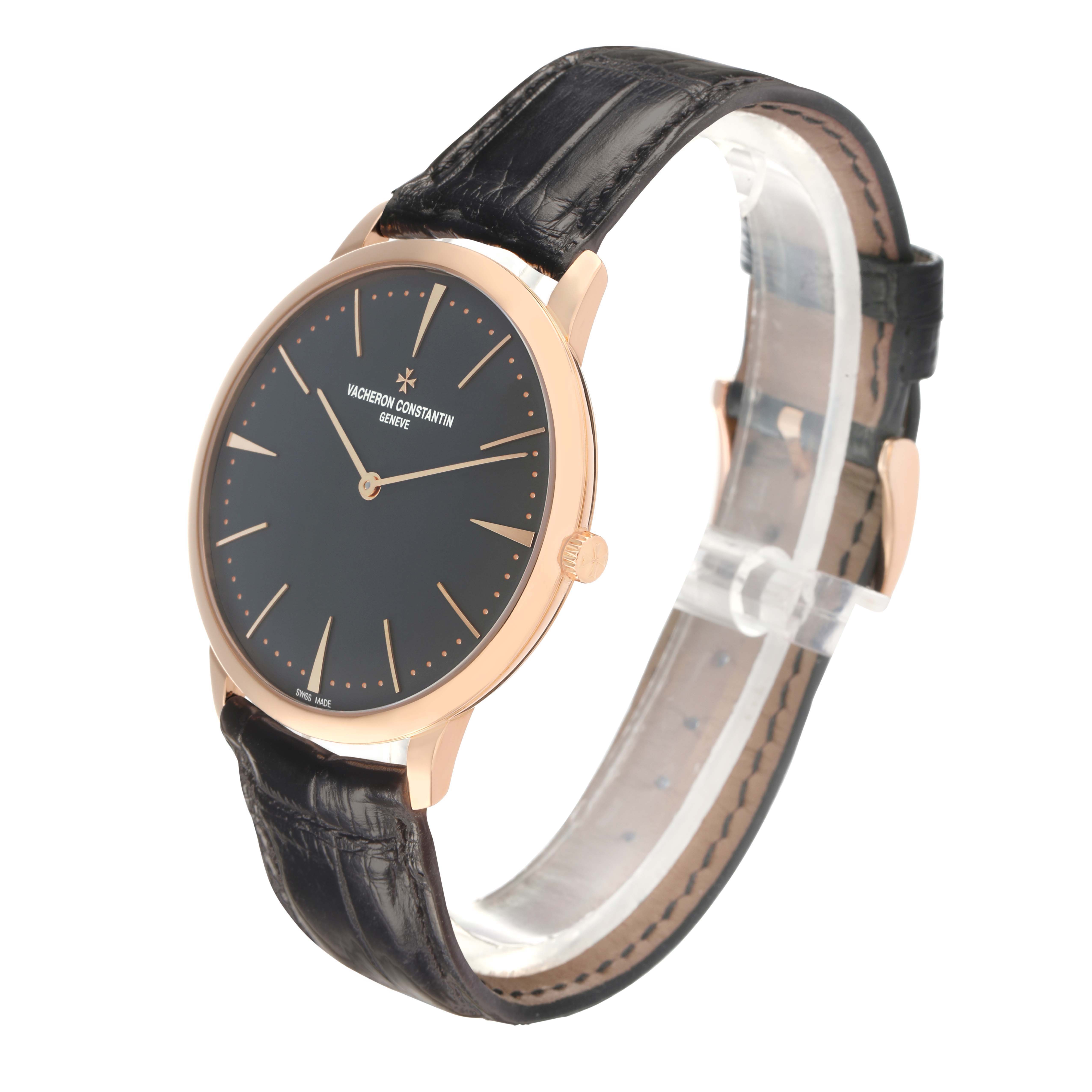 The Vacheron Constantin Patrimony 81180 Men's Rose Gold Grey Dial watch is shown at a three-quarter angle, highlighting its black dial, rose gold case, and leather strap.