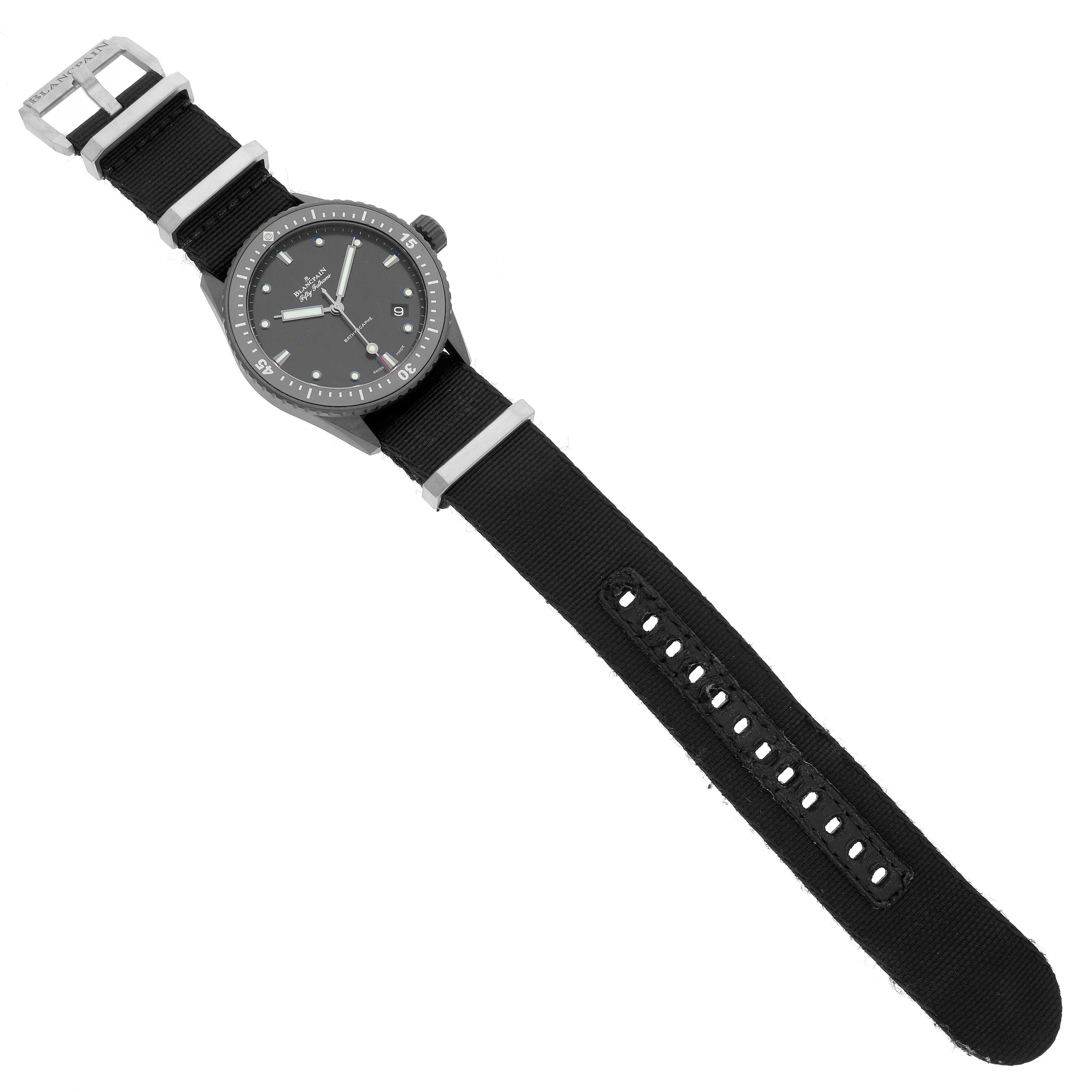 The Blancpain Fifty Fathoms 5000-0130-B52A Men's Stainless Steel Black Dial watch is shown from a top view, displaying the face, bezel, and black fabric strap with a buckle.