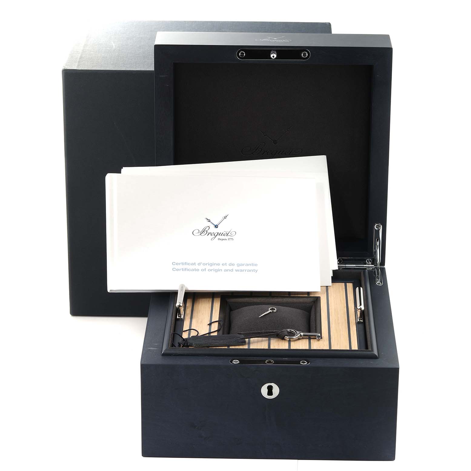 The image shows an opened box of the Breguet Classique 7137BB/Y5/9VU Men's White Gold Blue Dial 7137BB/Y5/9VU Men's White Gold Blue Dial watch, displaying the warranty certificate and accessories inside.
