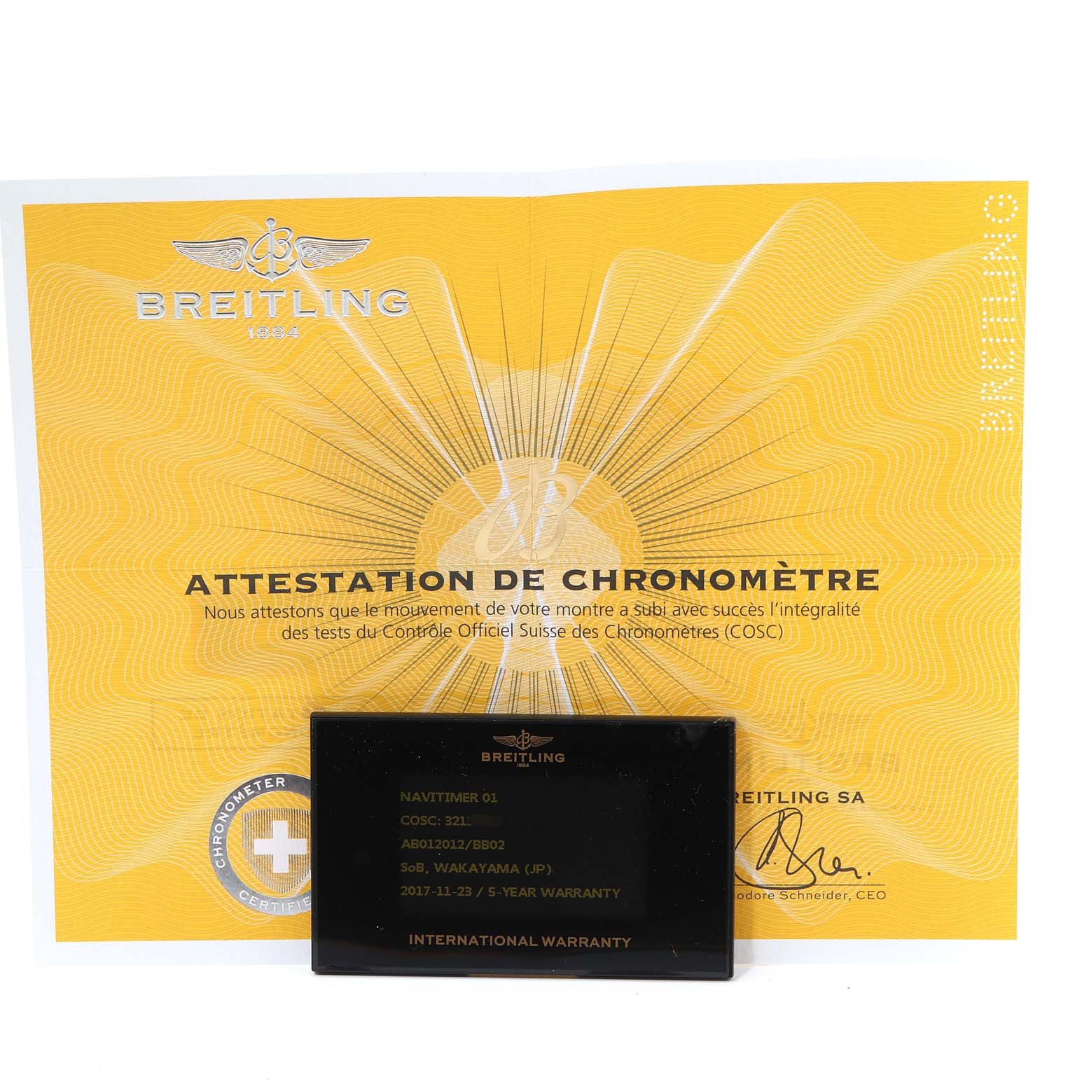 This image shows the Breitling Navitimer AB0120 Men's Stainless Steel Black Dial AB0120 Men's Stainless Steel Black Dial model's certification document and international warranty card from a front angle.