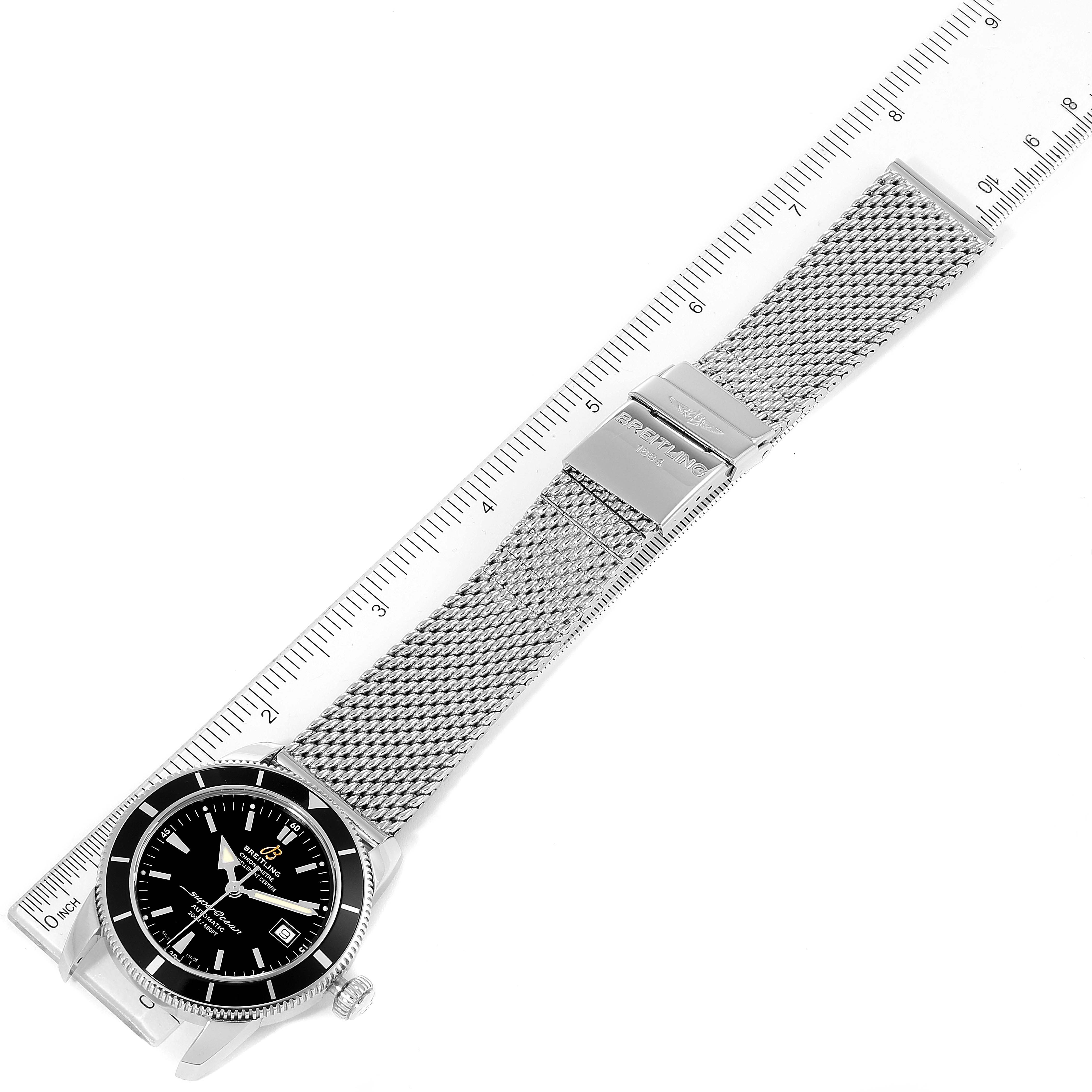 The image shows a Breitling Superocean A17321 Men's Stainless Steel Black Dial A17321 Men's Stainless Steel Black Dial watch laid out flat with the mesh strap and clasp visible, alongside a ruler for scale.