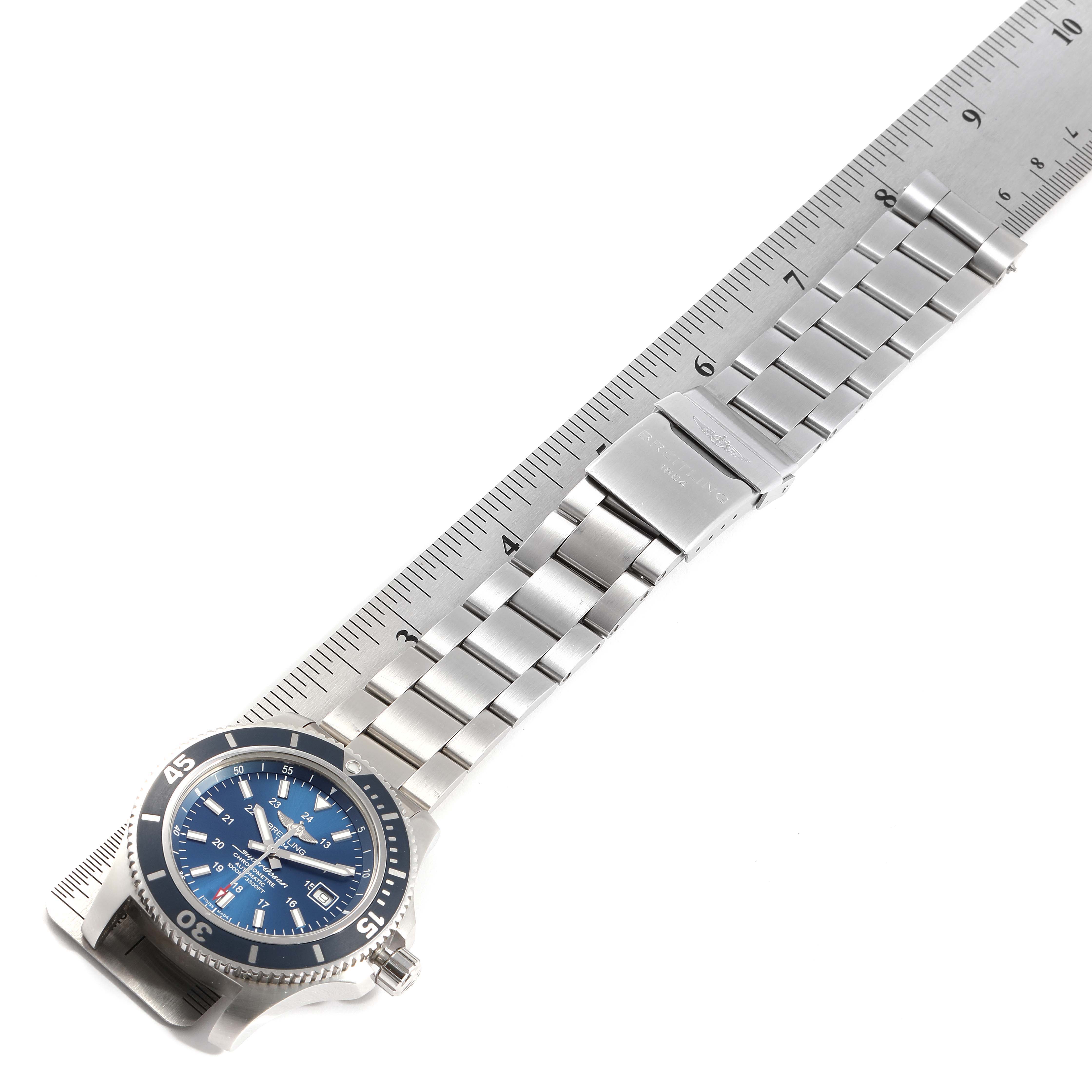 The Breitling Superocean A17392 Men's Stainless Steel Blue Dial A17392 Men's Stainless Steel Blue Dial watch is shown from a top-down angle, featuring its blue dial and stainless steel bracelet alongside a measuring scale.