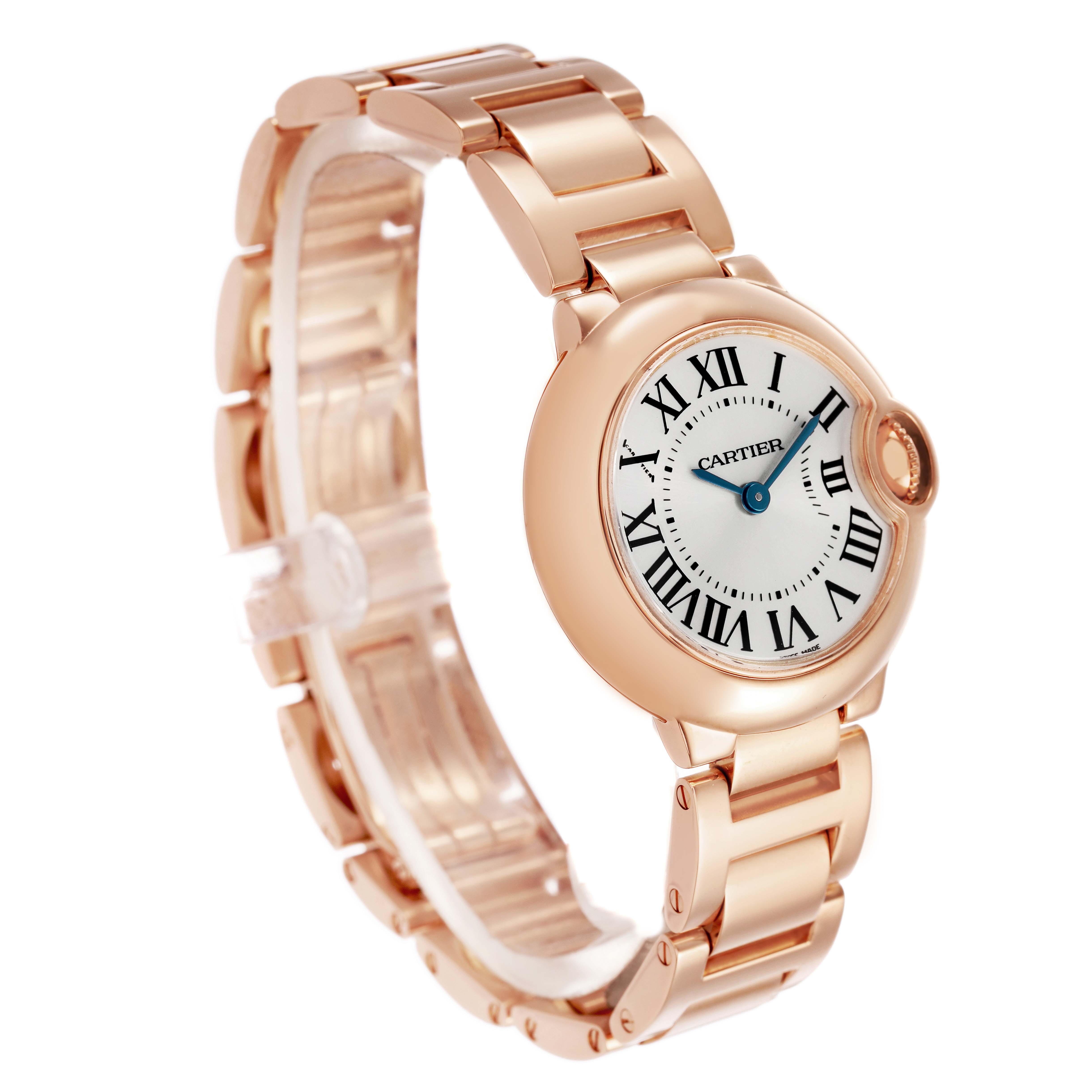 The image shows a Ballon Bleu by Cartier from a three-quarter angle, highlighting the watch face, Roman numerals, and metal bracelet.