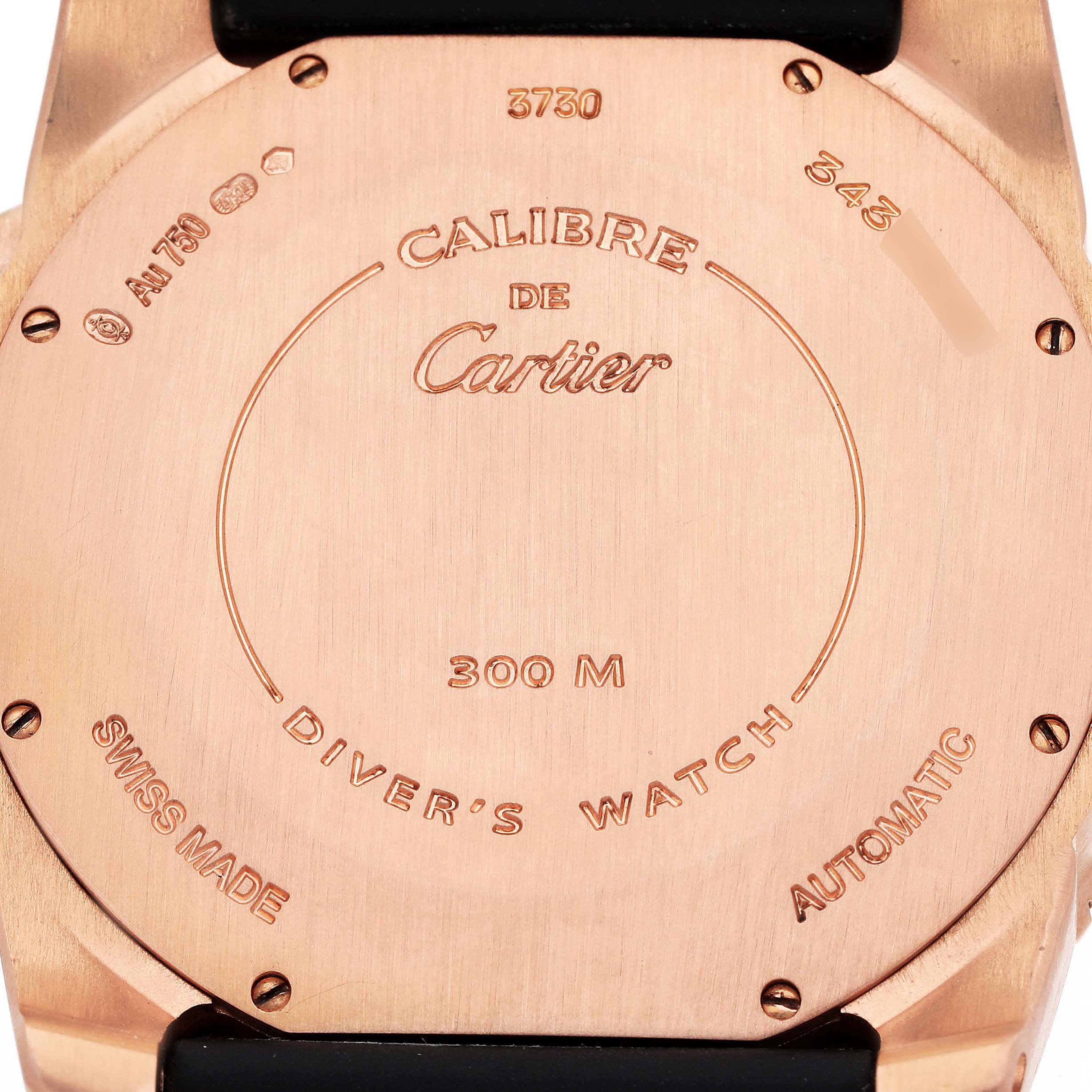 The image shows the case back of the Calibre de Cartier watch by Cartier with various engravings.