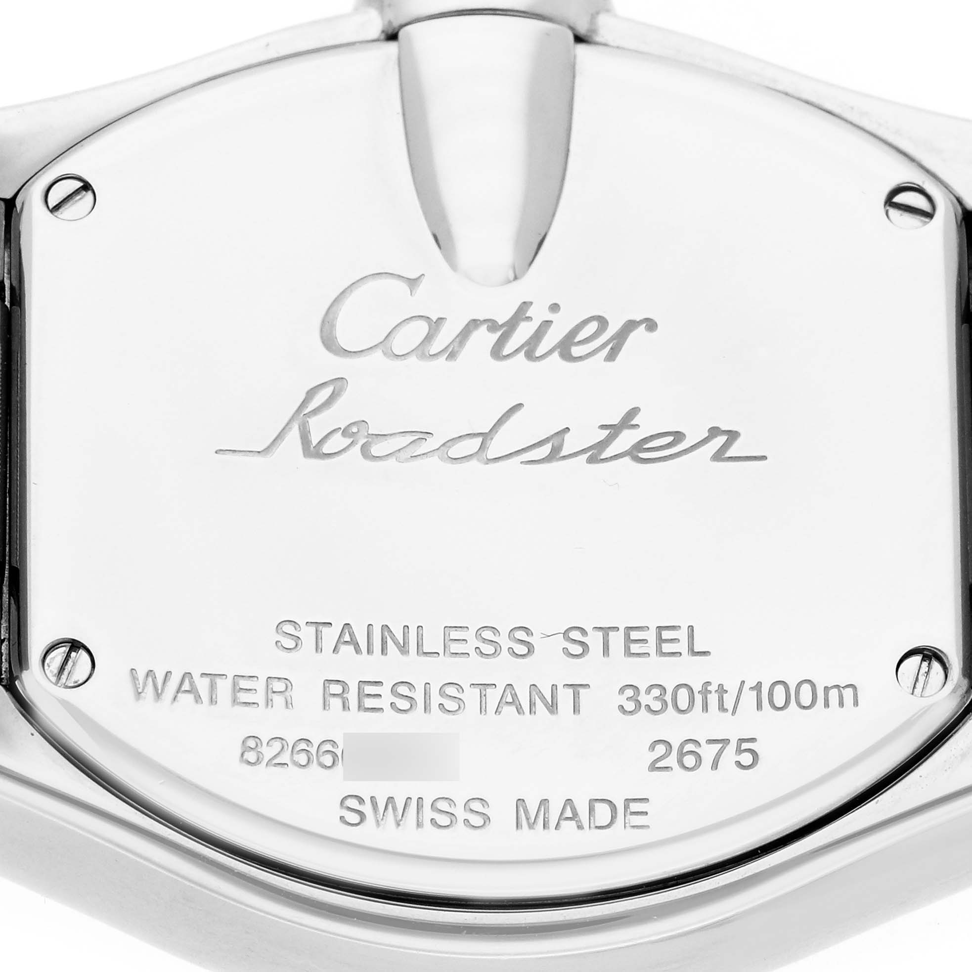 The image shows the back case of a Cartier Roadster W62016V3 Women
s Stainless Steel Silver Dial watch, displaying engravings like water resistance and material details.