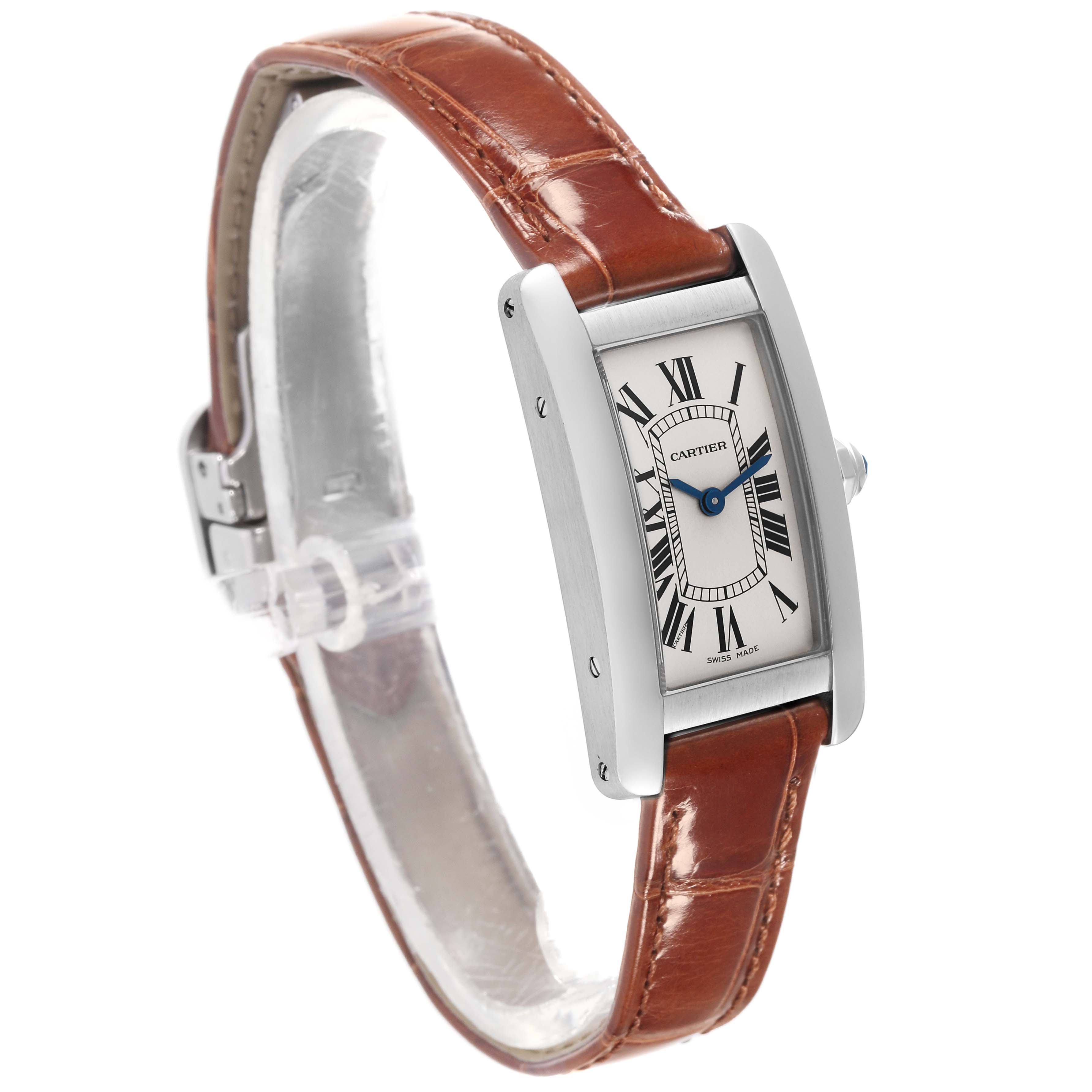 The Cartier Tank Americaine WSTA0016 Women's Stainless Steel Silver Dial WSTA0016 Women's Stainless Steel Silver Dial watch is shown at a three-quarter angle, highlighting the case, dial, and brown leather strap.