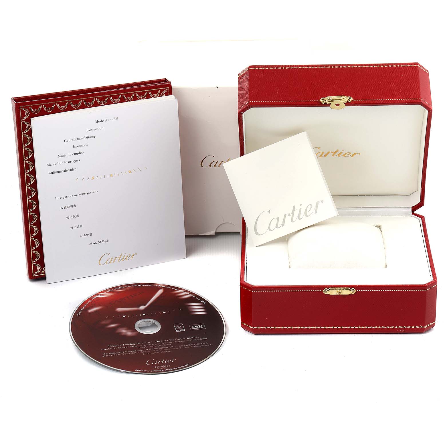 The image shows the Cartier Tank Anglaise W5310019 Women's Steel and Gold (two tone) Silver Dial W5310019 Women's Steel and Gold (two tone) Silver Dial watch's box, instruction manual, and a DVD from a frontal angle.