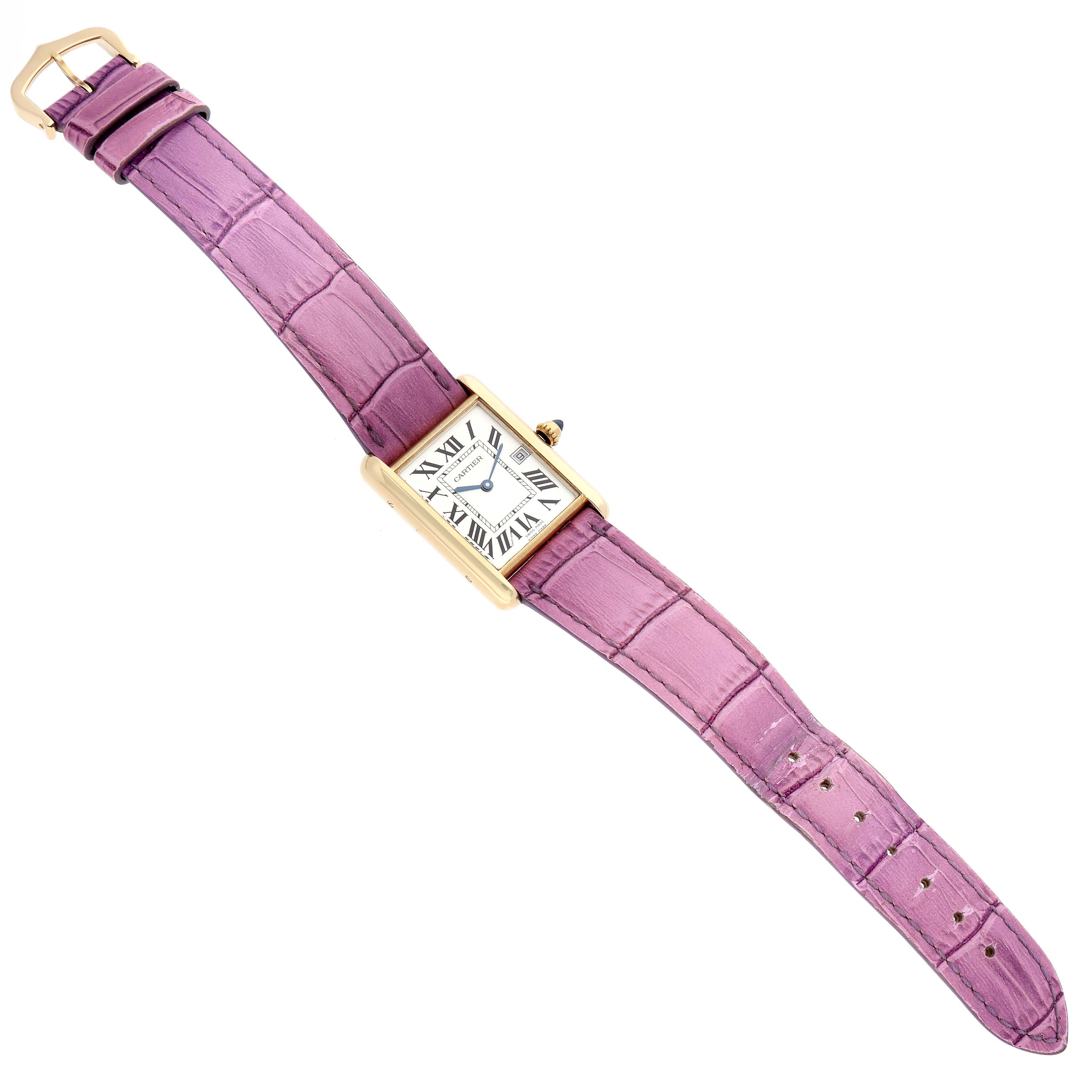 The Cartier Tank Louis W1529756 Men's Yellow Gold Silver Dial W1529756 Men's Yellow Gold Silver Dial watch is shown from a top-down angle, displaying its face, lavender strap, and gold case.