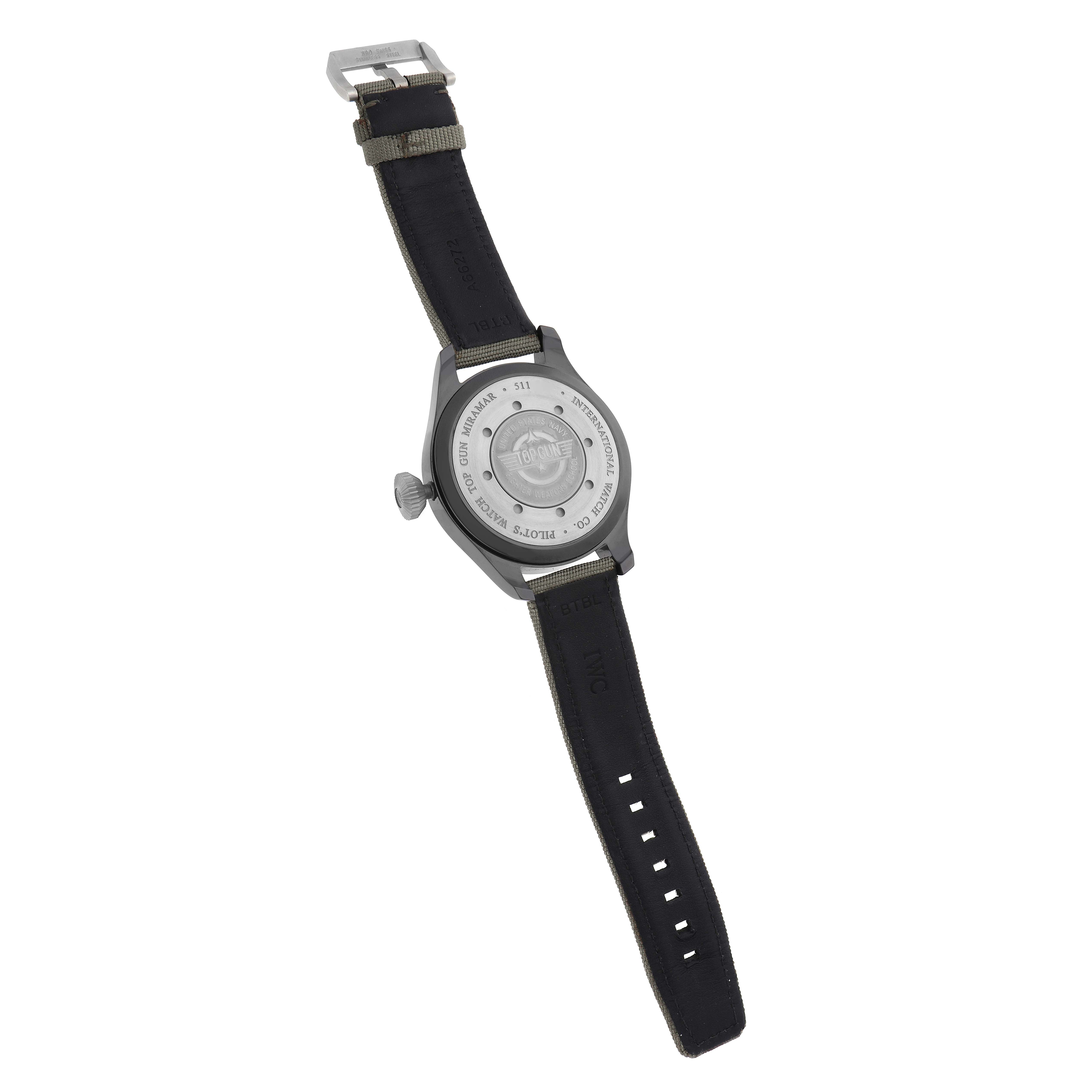 The IWC Pilot IW501902 Men
s Ceramic Grey Dial watch is shown from the back, displaying its case back and black strap with buckle.