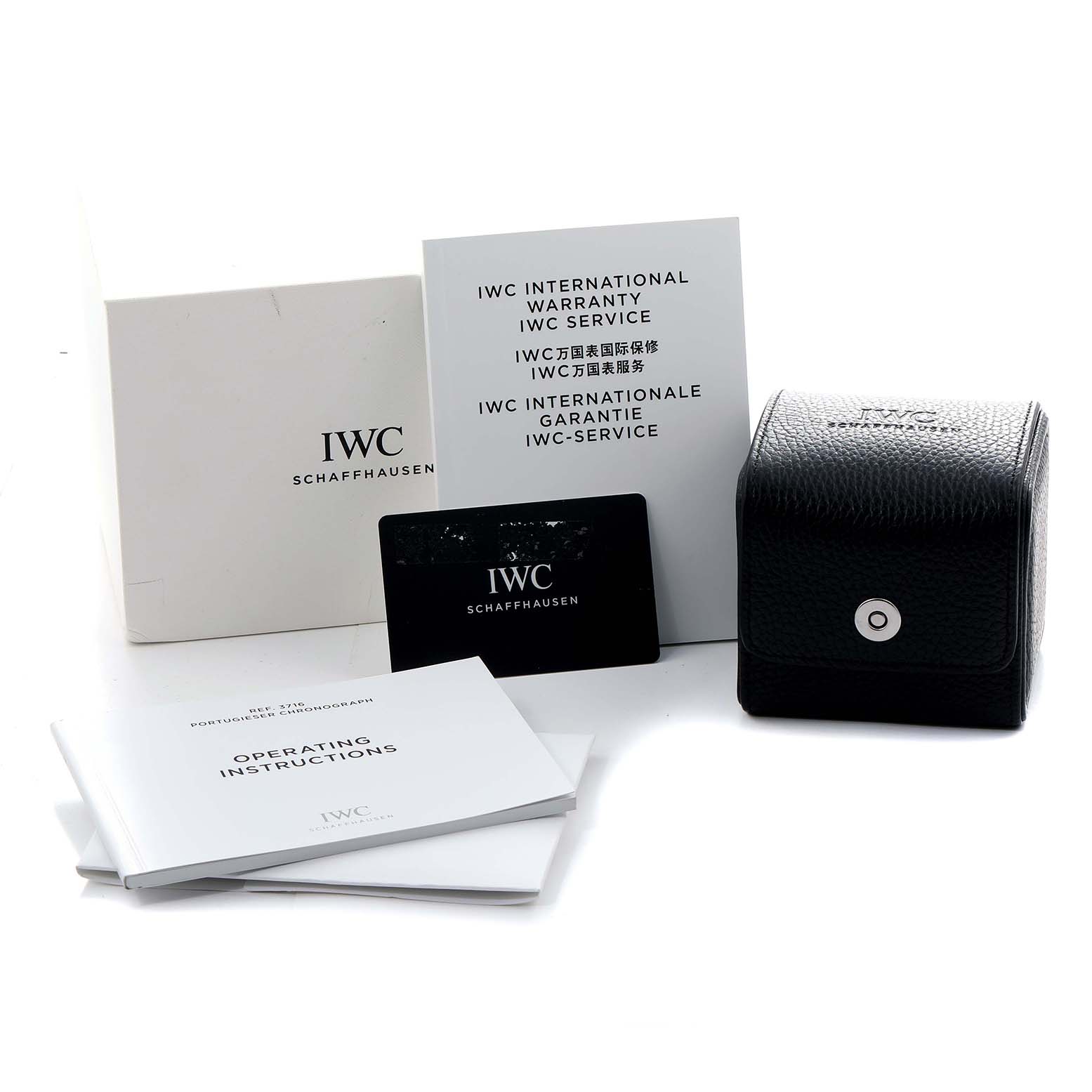 The image shows the accessories of an IWC Portuguese IW371609 Men
s Stainless Steel Black Dial model, including warranty cards, booklets, and a small black case.