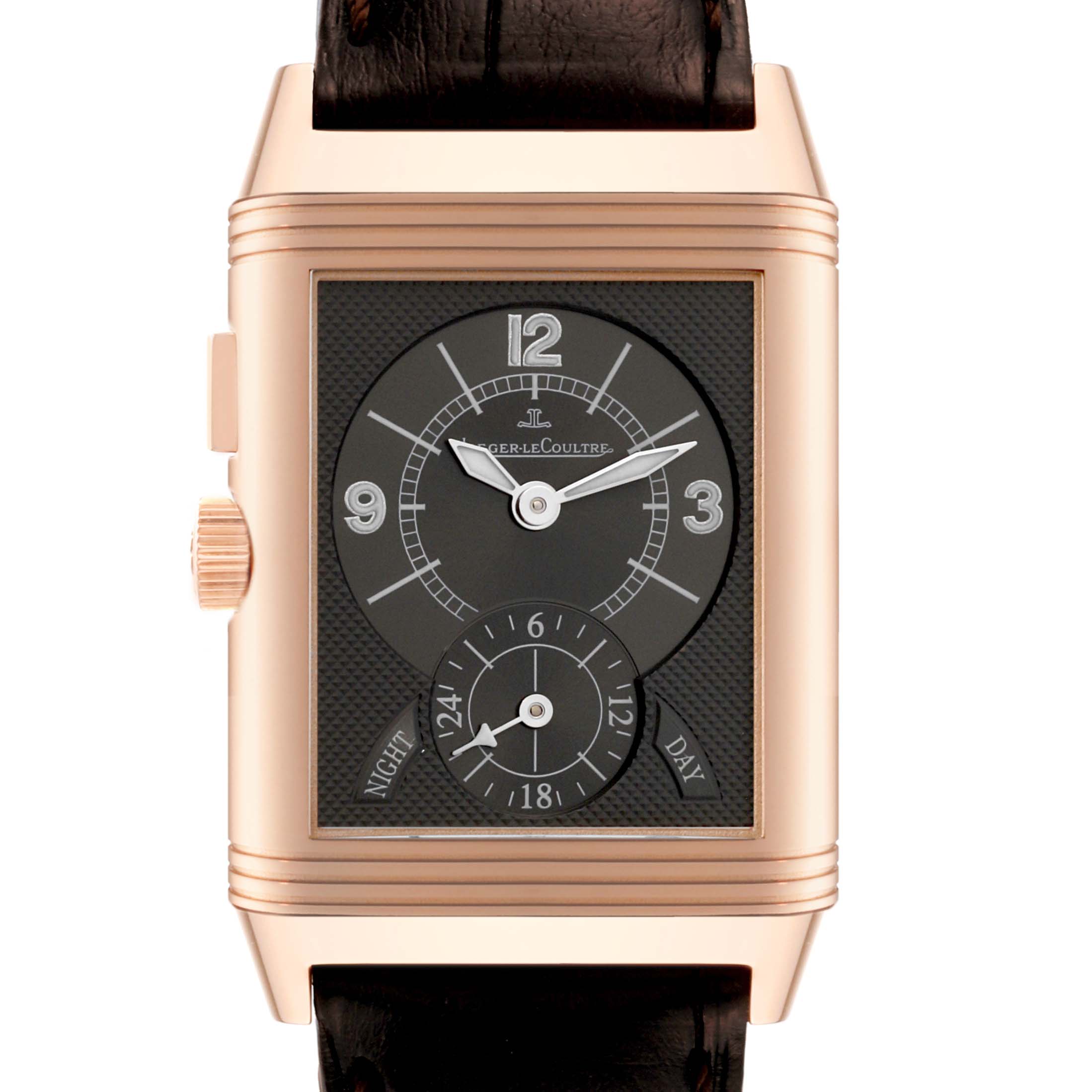 The image shows a front view of the Jaeger-LeCoultre Reverso watch, highlighting the dial, numbers, hands, and crown.