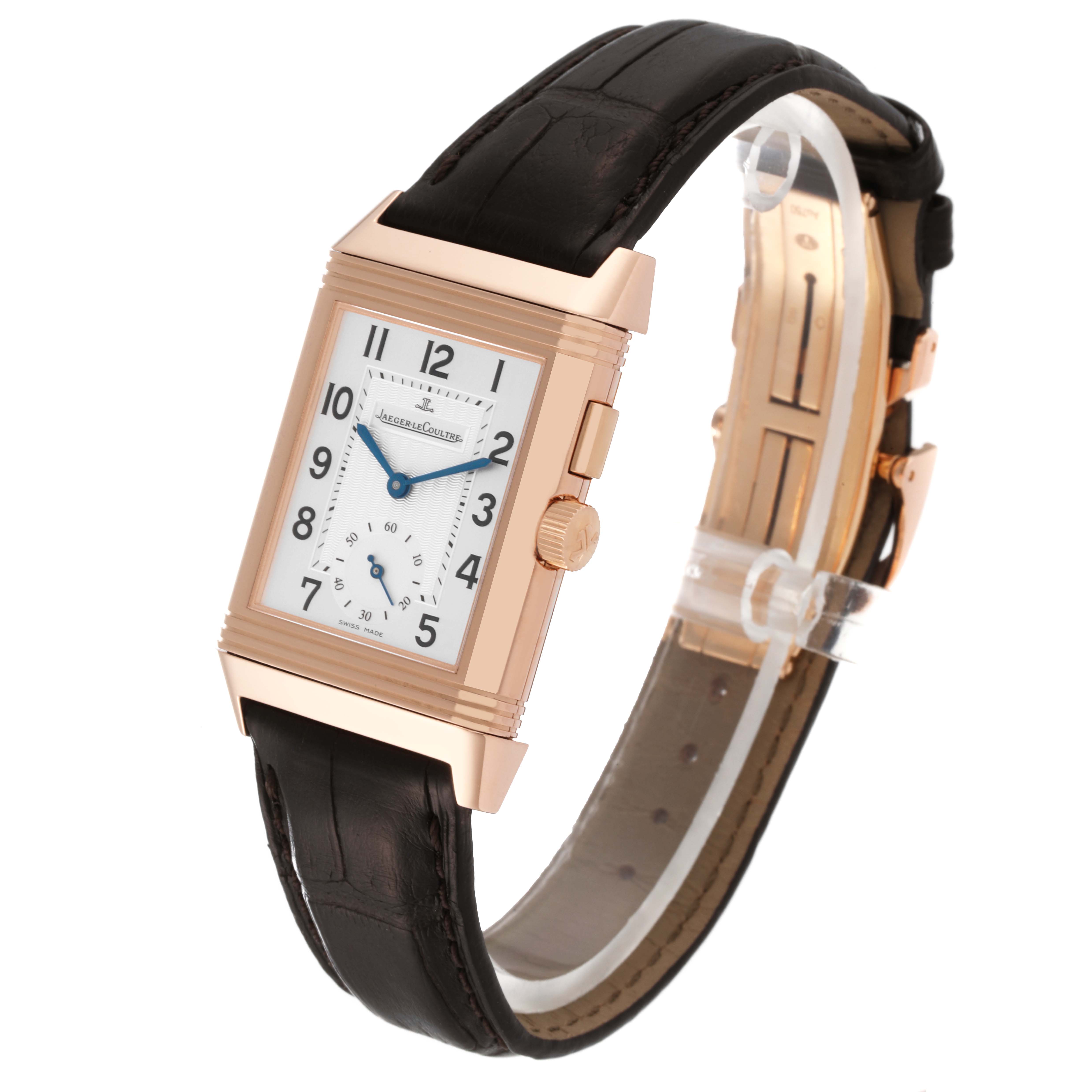 The image shows a close-up, angled view of a Jaeger LeCoultre Reverso Q2712411 Men's Rose Gold Silver Dial Q2712411 Men's Rose Gold Silver Dial model watch, highlighting its dial and black leather strap.