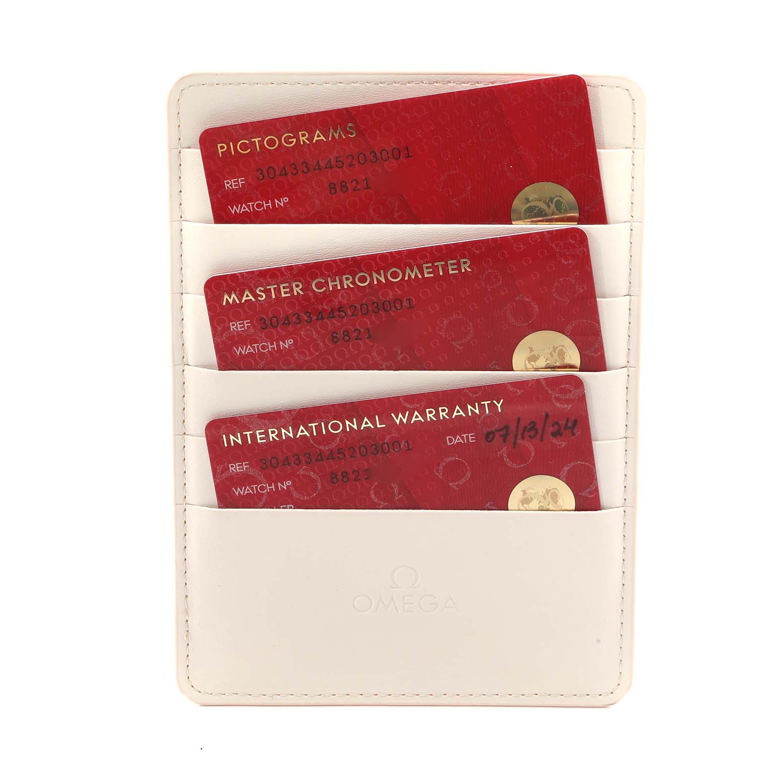 This image shows a white cardholder with three red Omega Speedmaster 304.33.44.52.03.001 Men
s Stainless Steel Blue Dial cards labeled Pictograms, Master Chronometer, and International Warranty.