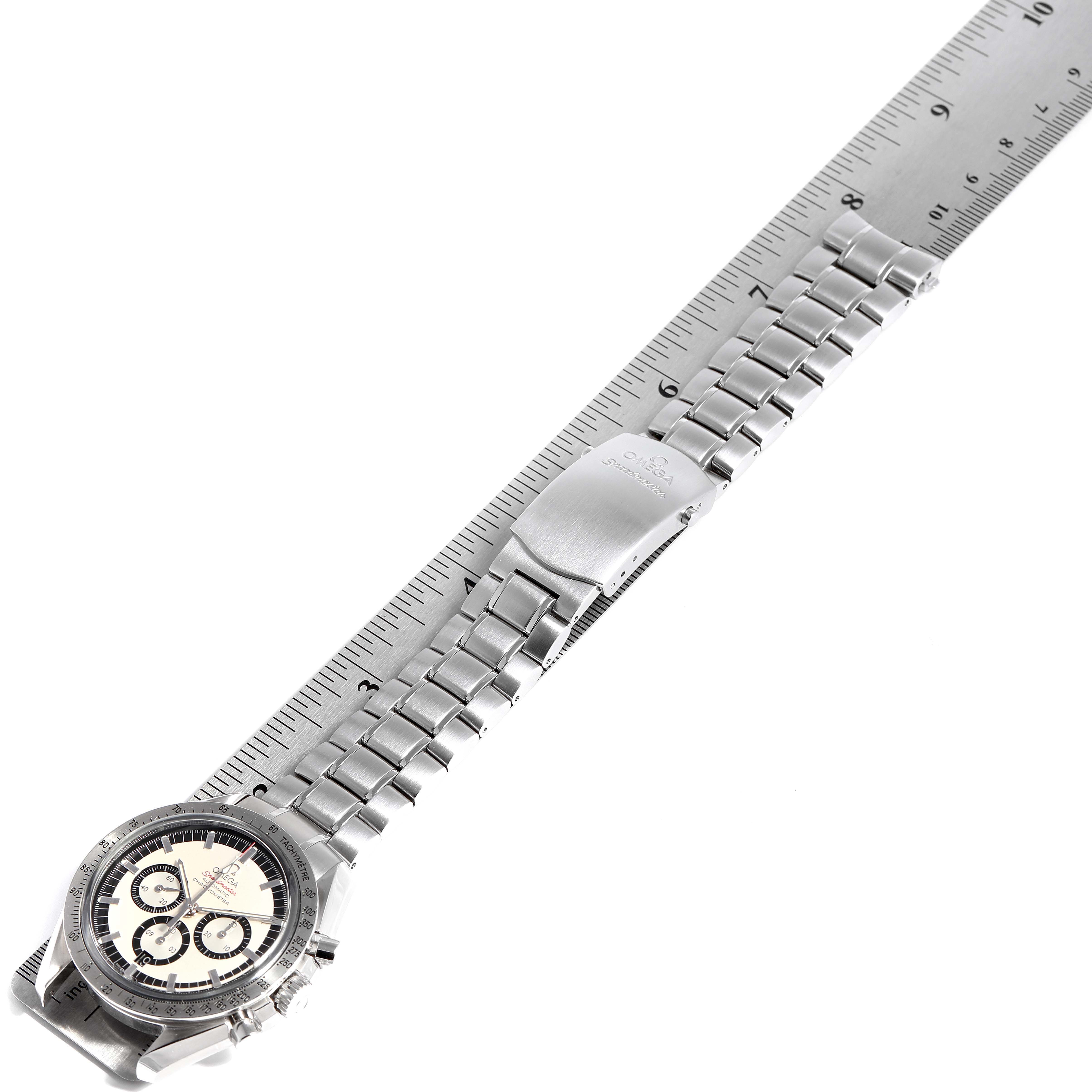 The image shows an Omega Speedmaster 3506.31.00 Men's Stainless Steel Silver Dial 3506.31.00 Men's Stainless Steel Silver Dial watch with a metal bracelet laid next to a ruler for size reference.