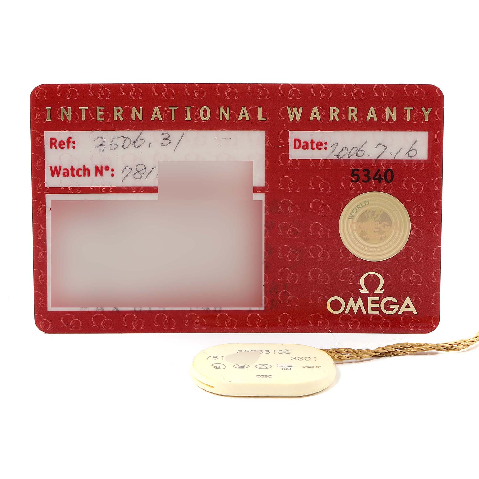 The image shows the Omega Speedmaster 3506.31.00 Men's Stainless Steel Silver Dial 3506.31.00 Men's Stainless Steel Silver Dial model's international warranty card and its attached tag.