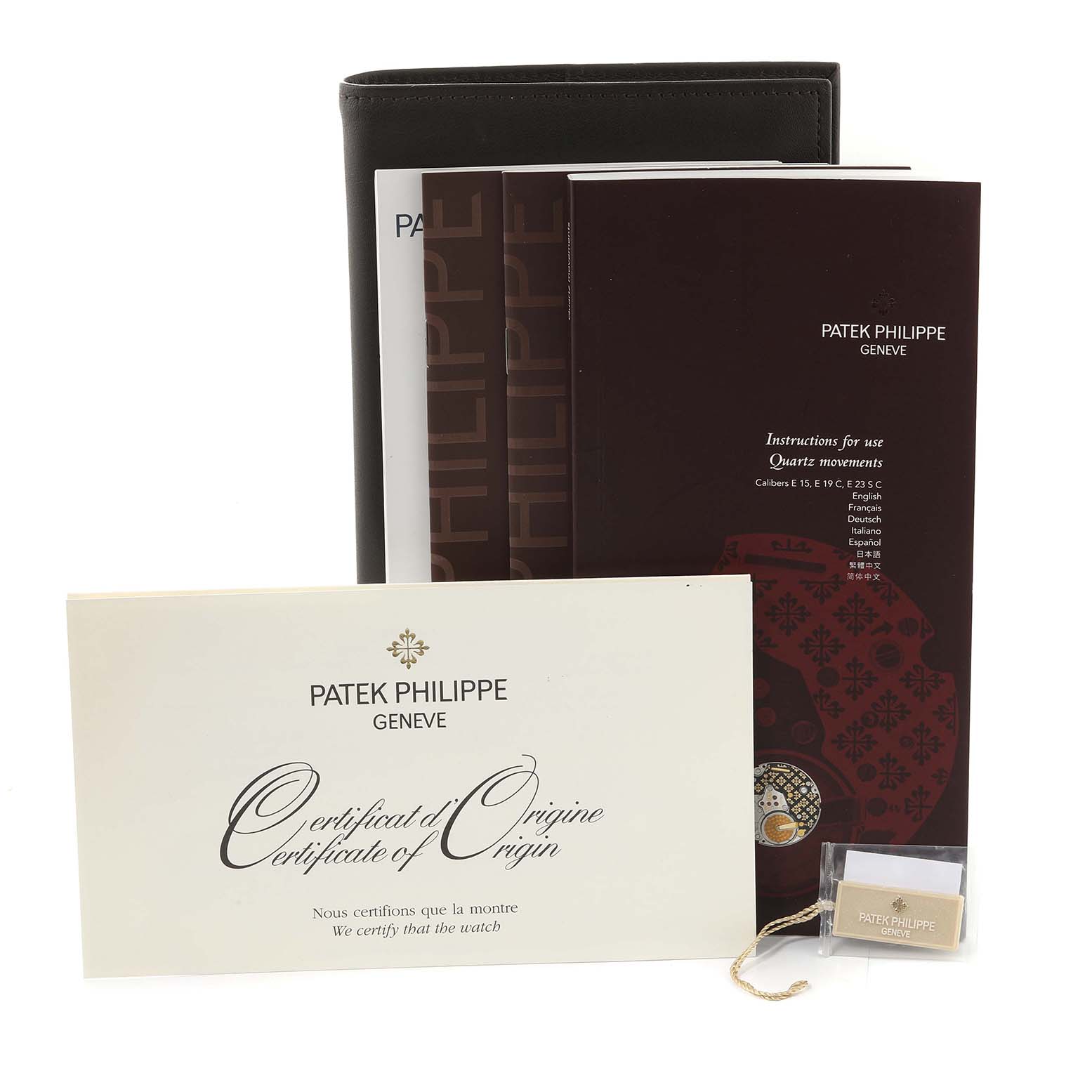 The image shows the certificate, instruction manual, booklet, and a tag for the Patek Philippe Twenty-4 4908/11R-011 Women's Rose Gold Silver Dial 4908/11R-011 Women's Rose Gold Silver Dial model watch.