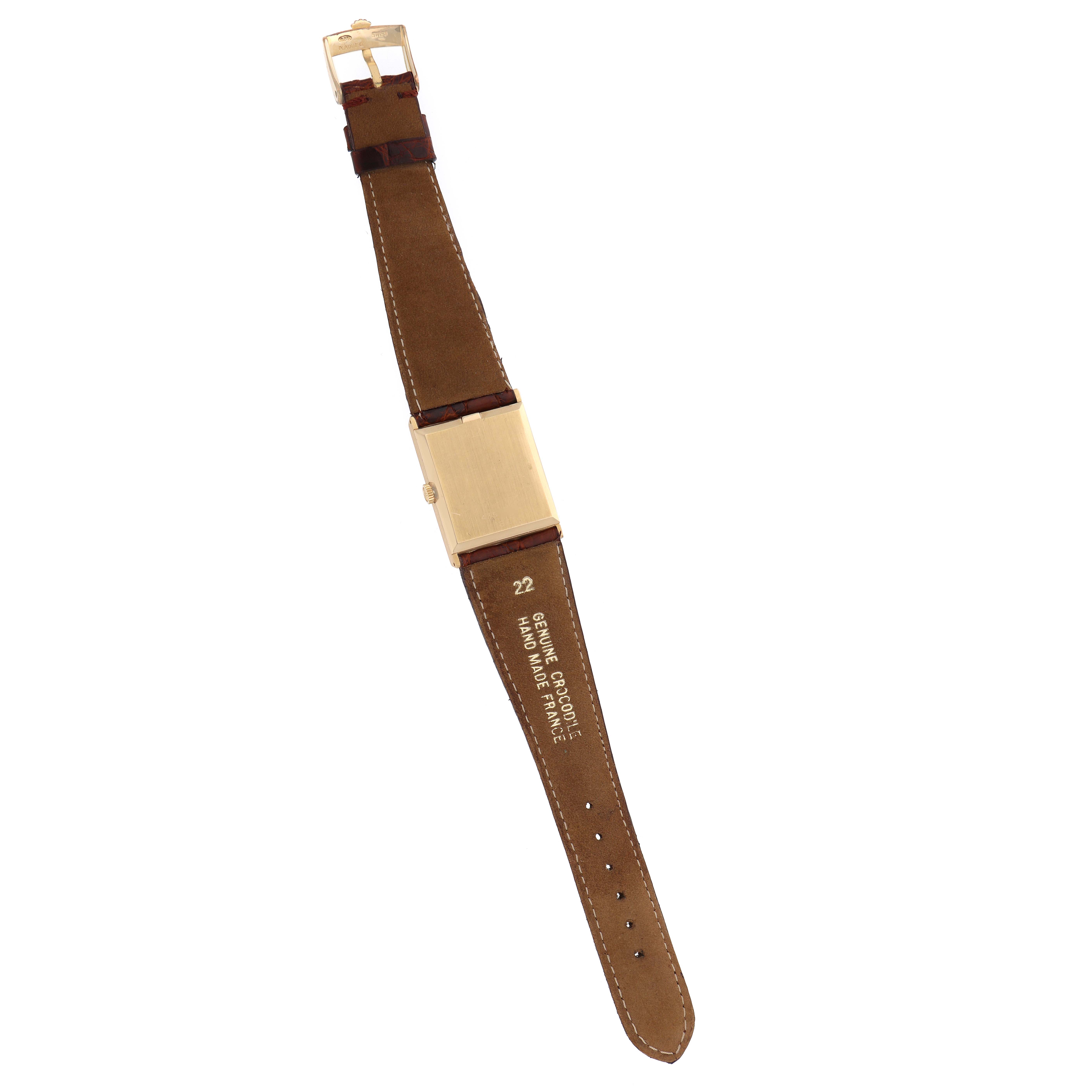 This image shows the back view of a Rolex Cellini 4127 Men
s Yellow Gold Champagne Dial watch, highlighting the leather strap, clasp, and case back.