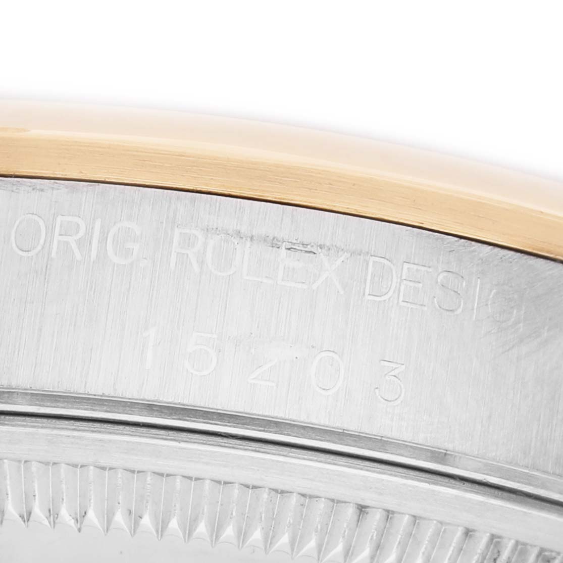 The image shows a close-up of the side engraving on the case back of a Rolex Date 15203 Men's Steel and Gold (two tone) White Dial model watch.