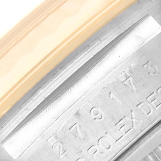 This close-up image shows a partial view of the bezel and engraved serial number on a Rolex Datejust 279173 Women's Steel and Gold (two tone) Silver Dial 279173 Women's Steel and Gold (two tone) Silver Dial watch.