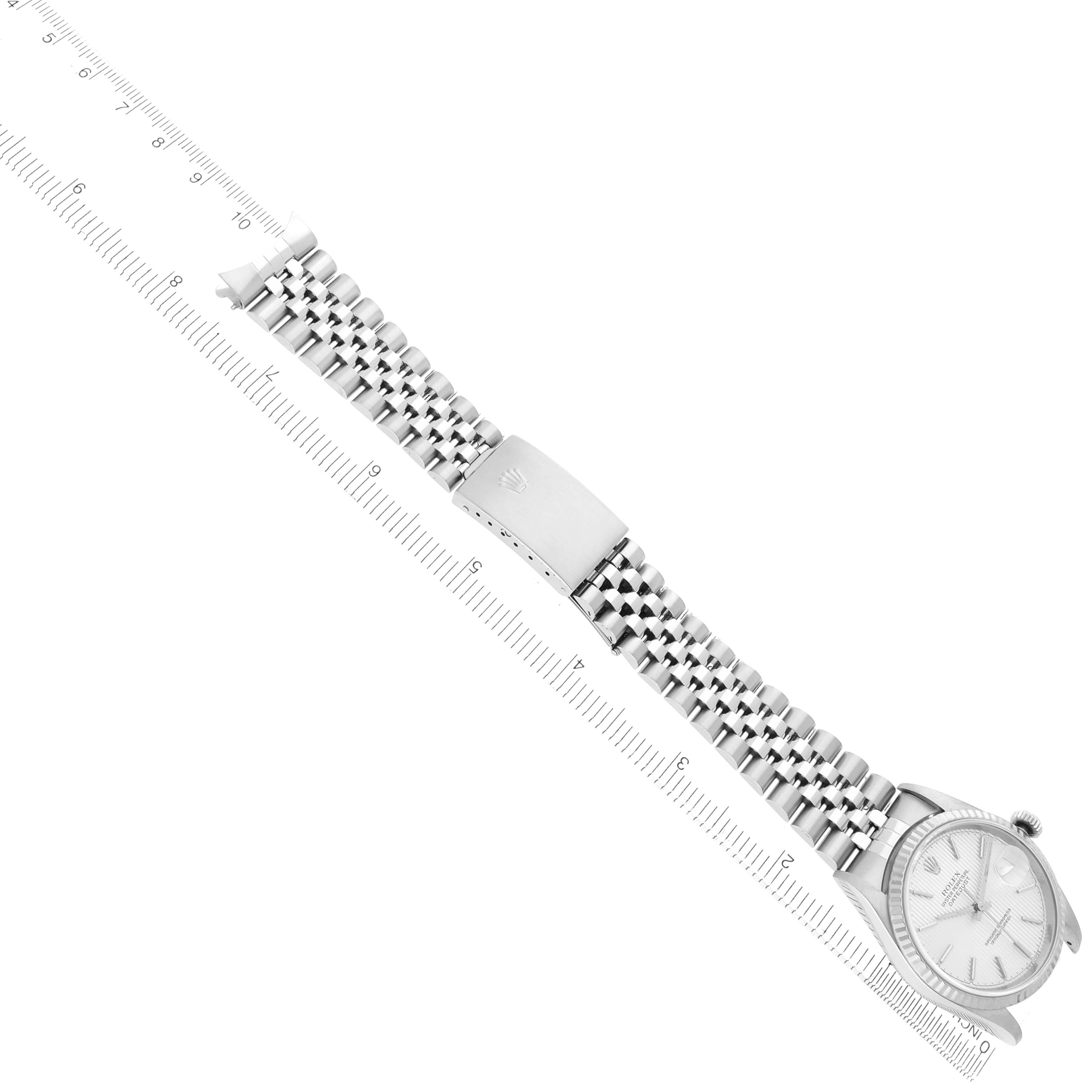 The image shows a Rolex Datejust 16234 Men
s Stainless Steel Silver Dial watch partially from an overhead angle, highlighting the bracelet and clasp.