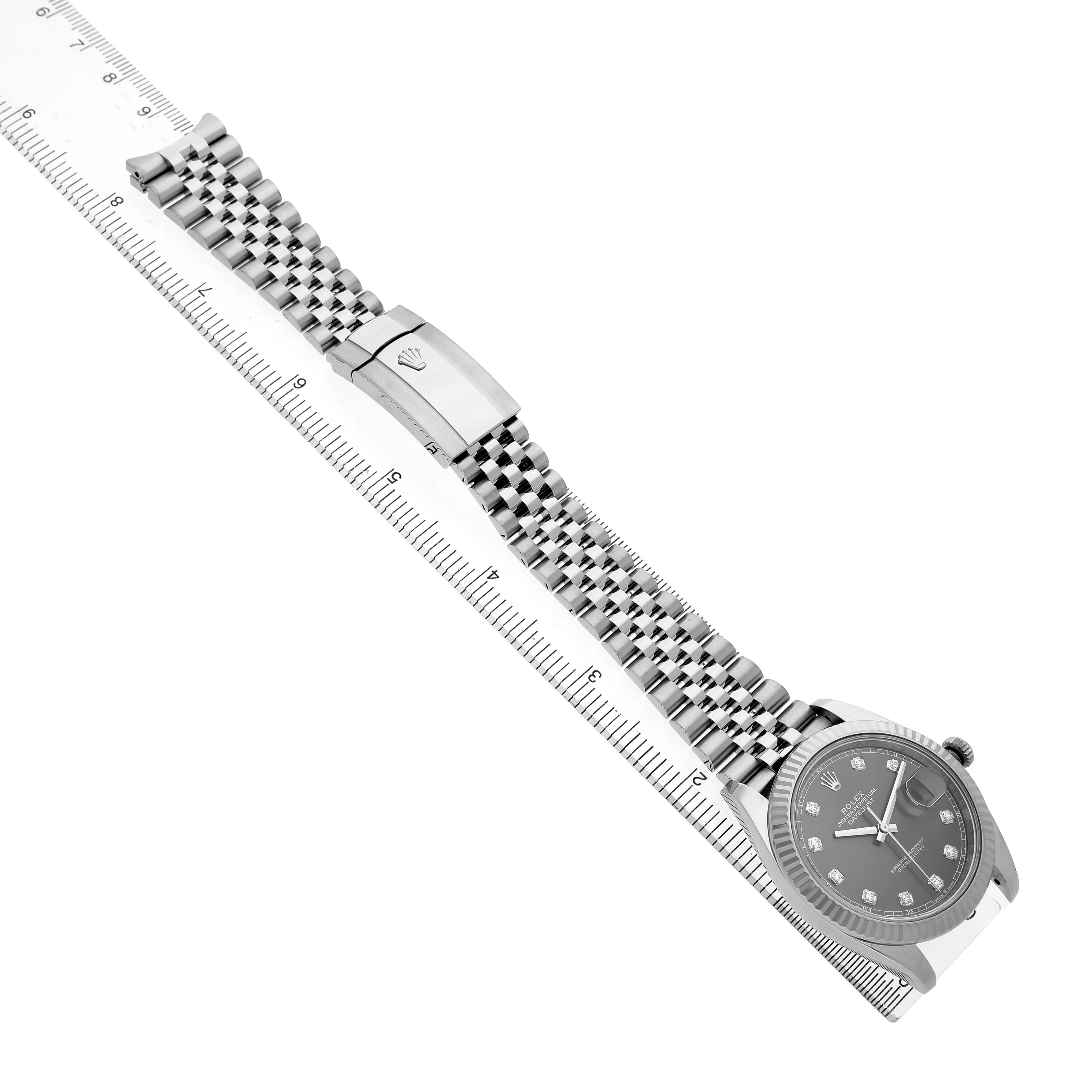 The Rolex Datejust 41 126334 Men's Stainless Steel Grey Dial is shown from an angled top view, highlighting its bracelet, clasp, dial, and ruler for scale.