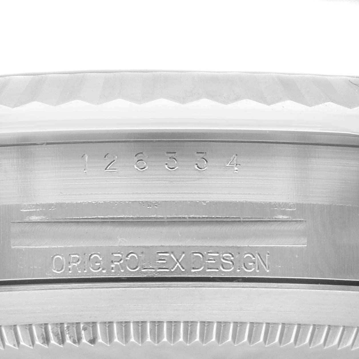 This image shows a close-up of the Rolex Datejust 41 126334 Men's Stainless Steel Black Dial 126334 Men's Stainless Steel Black Dial model's serial number and "ORIG ROLEX DESIGN" engraving on its case.
