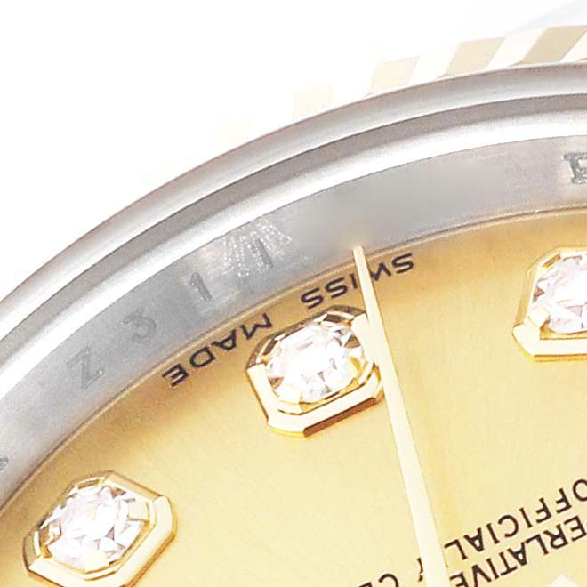 Close-up of a Rolex Datejust 179173 Women's Steel and Gold (two tone) Champagne Dial 179173 Women's Steel and Gold (two tone) Champagne Dial watch showing part of the dial, bezel, and diamond markers.