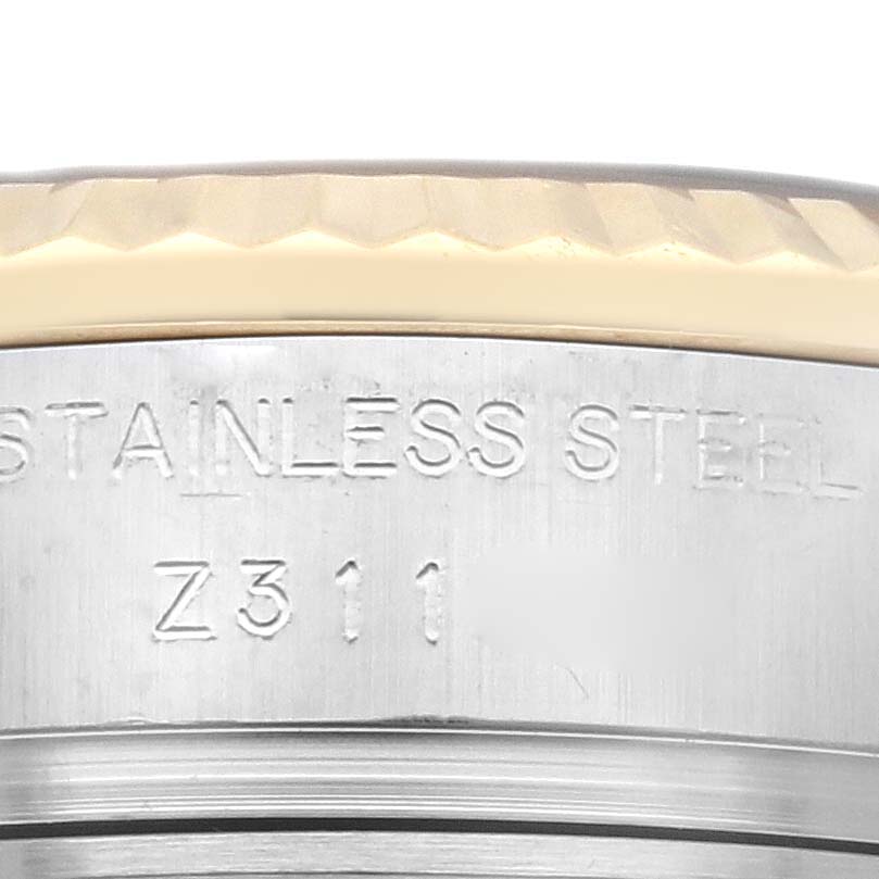 This image shows a close-up of the side of the casing and bezel of a Rolex Datejust 179173 Women's Steel and Gold (two tone) Champagne Dial 179173 Women's Steel and Gold (two tone) Champagne Dial watch, highlighting the "Stainless Steel" engraving.