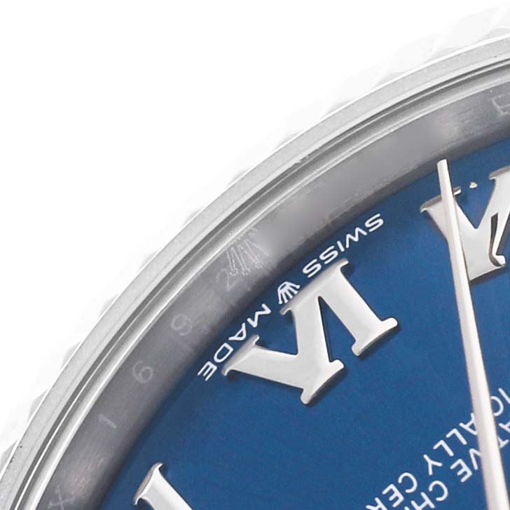 The image shows a close-up of the dial and bezel of a Mid-Size Rolex watch, focusing on the Roman numeral and text details.
