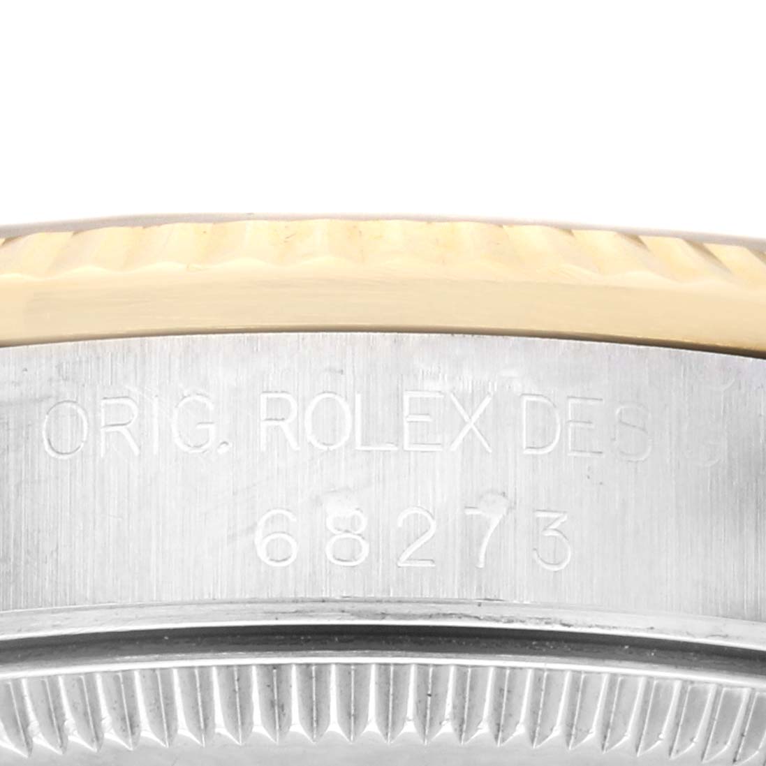 This is a close-up shot of the side of a Rolex Mid-Size 68273 Women's Steel and Gold (two tone) White Dial 68273 Women's Steel and Gold (two tone) White Dial model watch, showing the engraved serial number and part of the bezel.