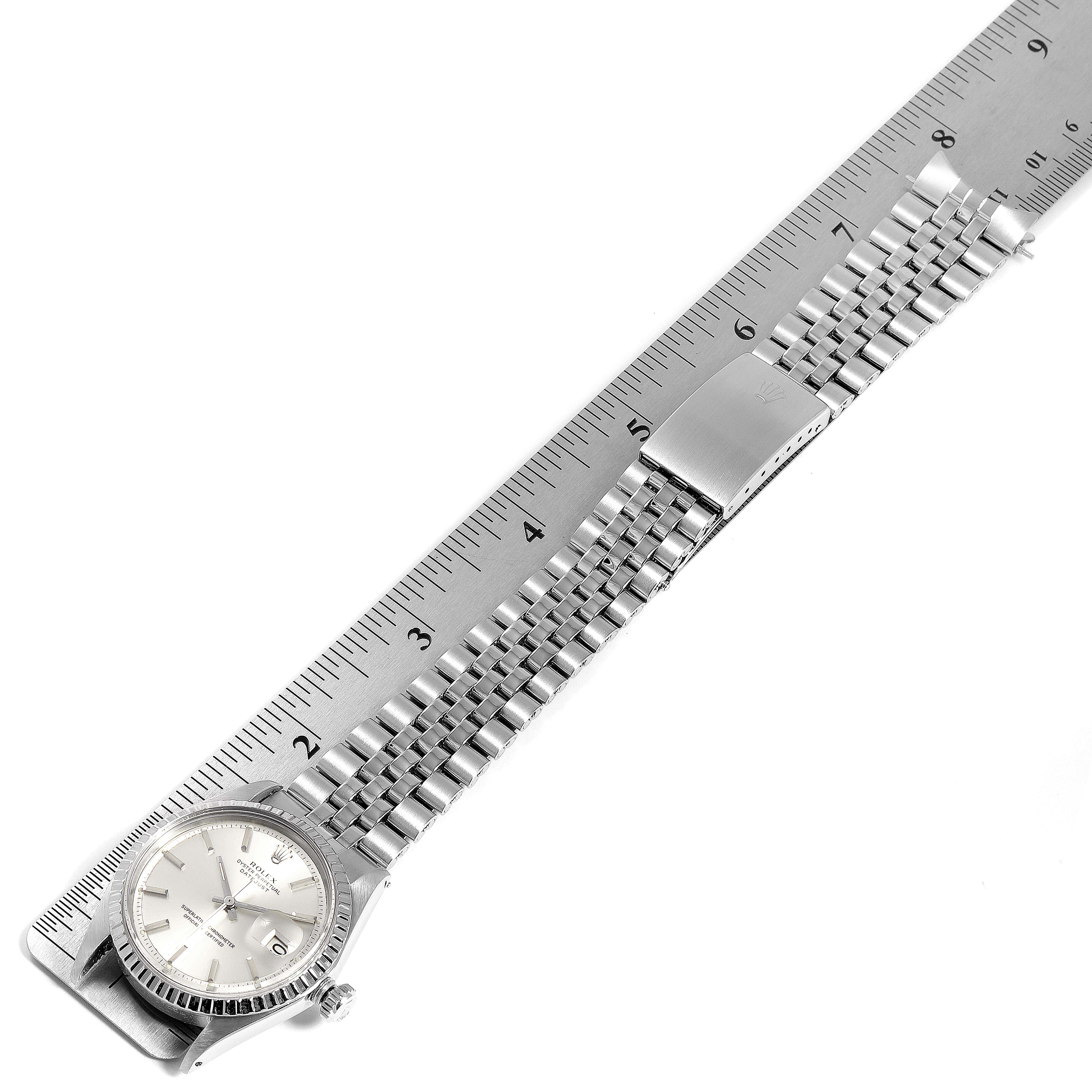 The image shows a Rolex Vintage Collection 1603 Men's Stainless Steel Silver Dial 1603 Men's Stainless Steel Silver Dial watch laid flat, with its bracelet and clasp visible, aligned next to a ruler for size measurement.