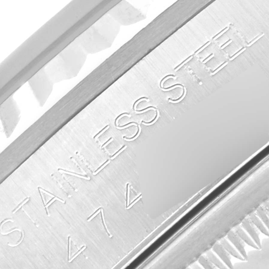 The image shows a close-up angle of a stainless steel part of the Rolex Datejust 16234 Men's Stainless Steel Silver Dial 16234 Men's Stainless Steel Silver Dial watch, highlighting the engraved text.