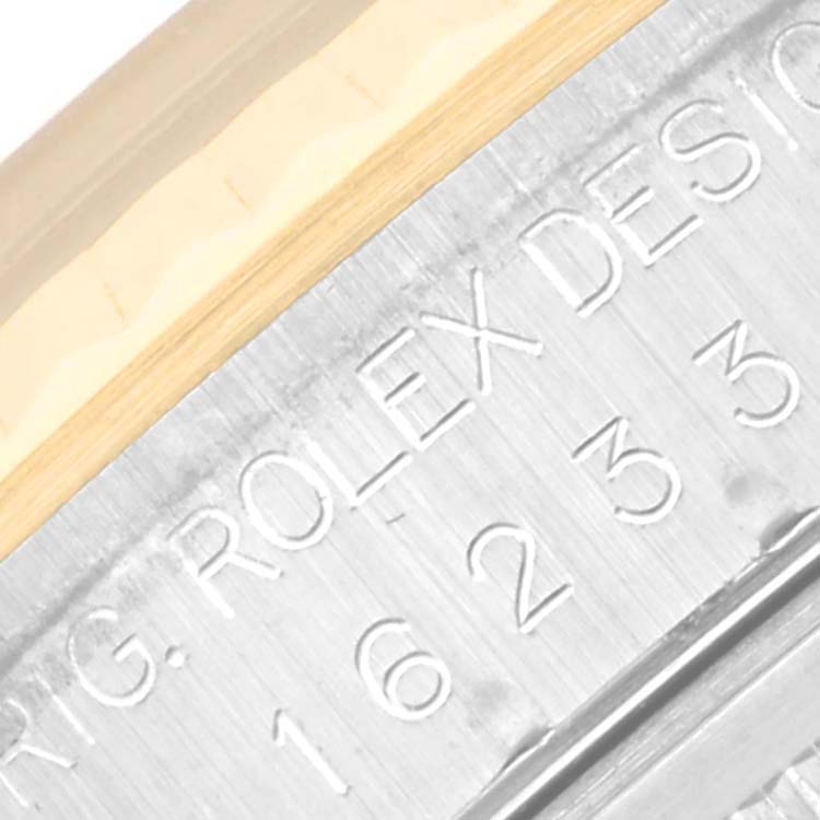 This image shows a close-up of the Datejust model by Rolex, focusing on the engraved serial number and bezel area.