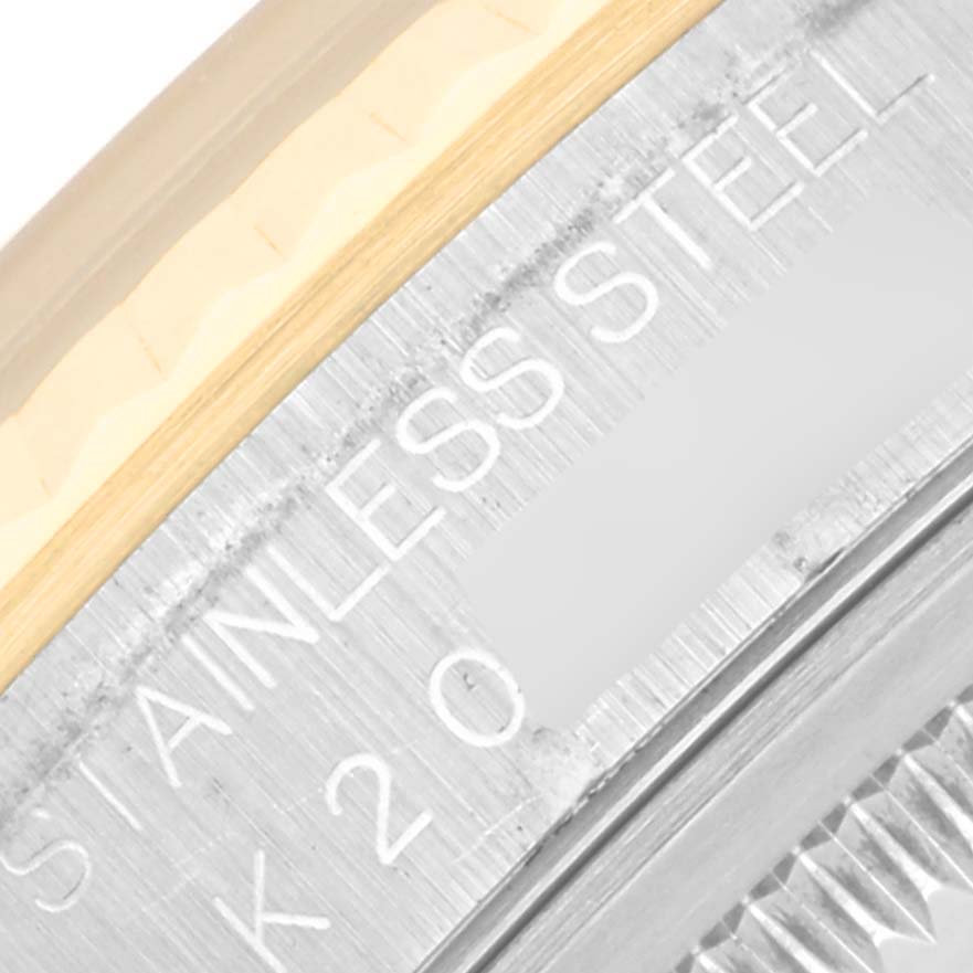 The image shows a close-up angle of the side engraving on the stainless steel case of a Rolex Datejust 16233 Men's Steel and Gold (two tone) Black Dial 16233 Men's Steel and Gold (two tone) Black Dial watch.