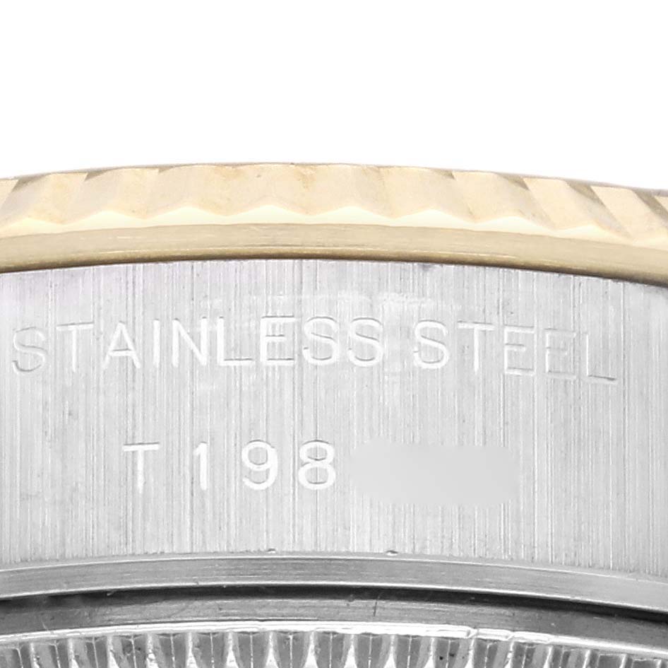 This image shows a close-up of the case side and edge of the bezel for the Rolex Datejust 69173 Women's Steel and Gold (two tone) Champagne Dial 69173 Women's Steel and Gold (two tone) Champagne Dial model, with "Stainless Steel" engraved.