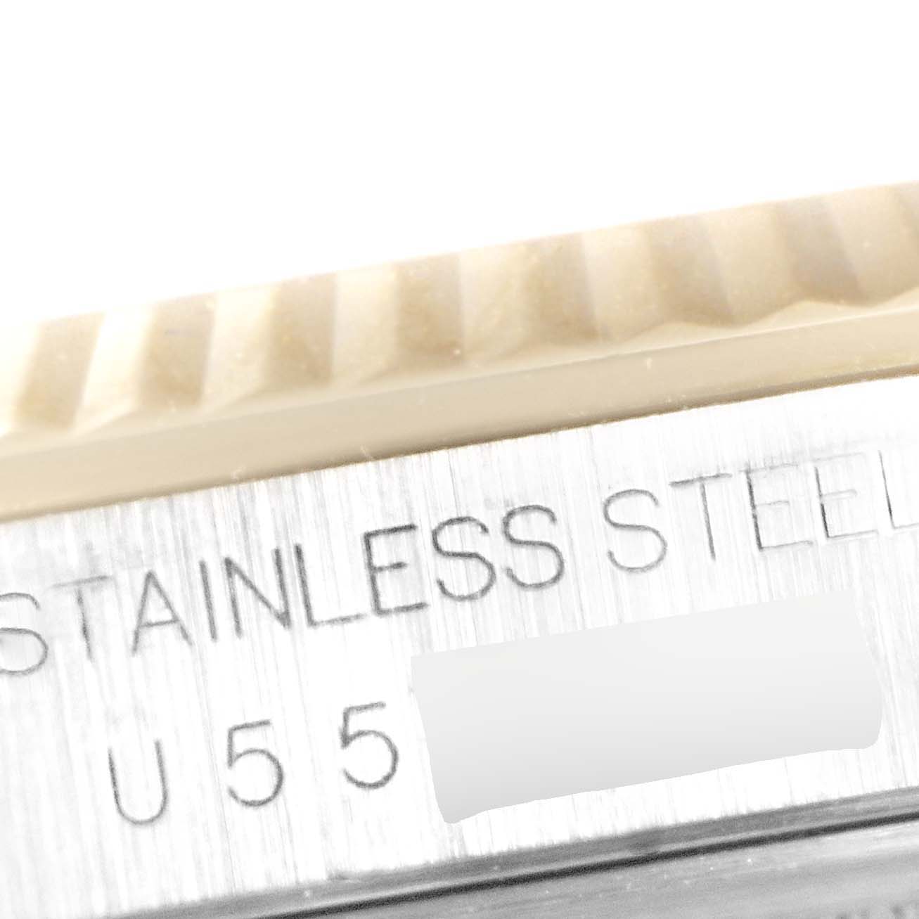 The image shows a close-up of the case and bezel of a Rolex Datejust 16233 Men
s Steel and Gold (two tone) Mother of Pearl Dial 16233 Men
s Steel and Gold (two tone) Mother of Pearl Dial watch, emphasizing the "STAINLESS STEEL" engraving.