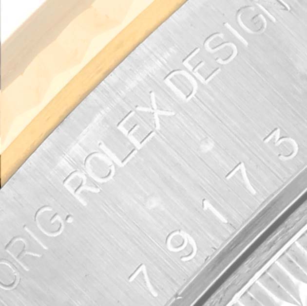 This close-up angle shows the engraved reference number and part of the bezel on a Rolex Datejust 79173 Women's Steel and Gold (two tone) Silver Dial 79173 Women's Steel and Gold (two tone) Silver Dial watch.