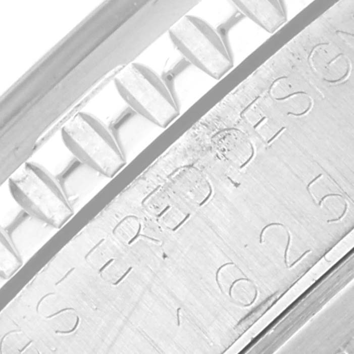 This close-up photo of the Vintage Collection Rolex watch shows parts of the bezel and engraved text on the casing.