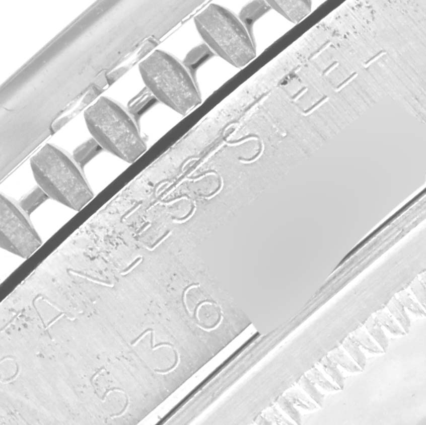 Close-up of the Rolex Vintage Collection 1625/4 Men's Stainless Steel Silver Dial 1625/4 Men's Stainless Steel Silver Dial watch, focusing on the stainless steel engraving and part of the bezel.