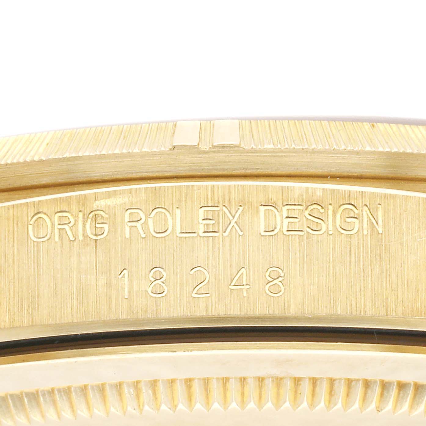 This close-up image shows the engraved model number and branding on the case of a Rolex President 18248 Men's Yellow Gold Champagne Dial 18248 Men's Yellow Gold Champagne Dial watch.