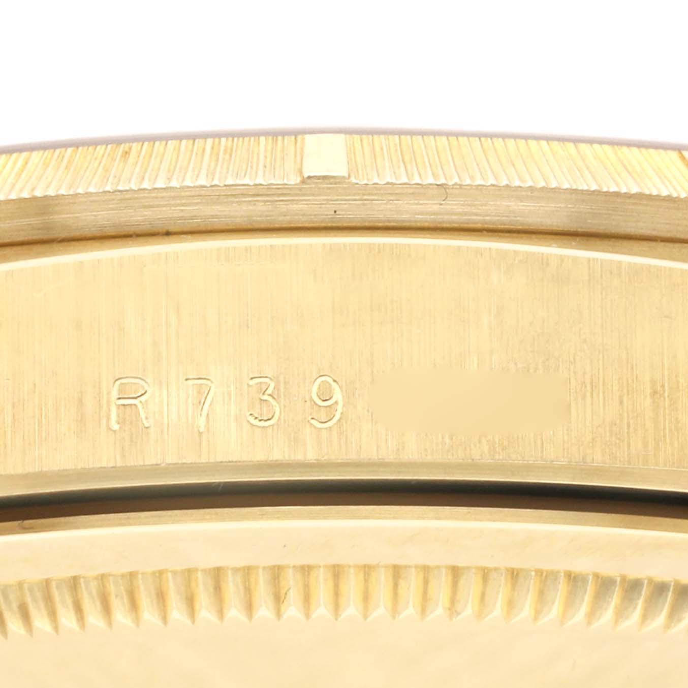 This close-up image shows the case back and edge of a Rolex President 18248 Men's Yellow Gold Champagne Dial 18248 Men's Yellow Gold Champagne Dial model, displaying its serial number and fluted bezel.