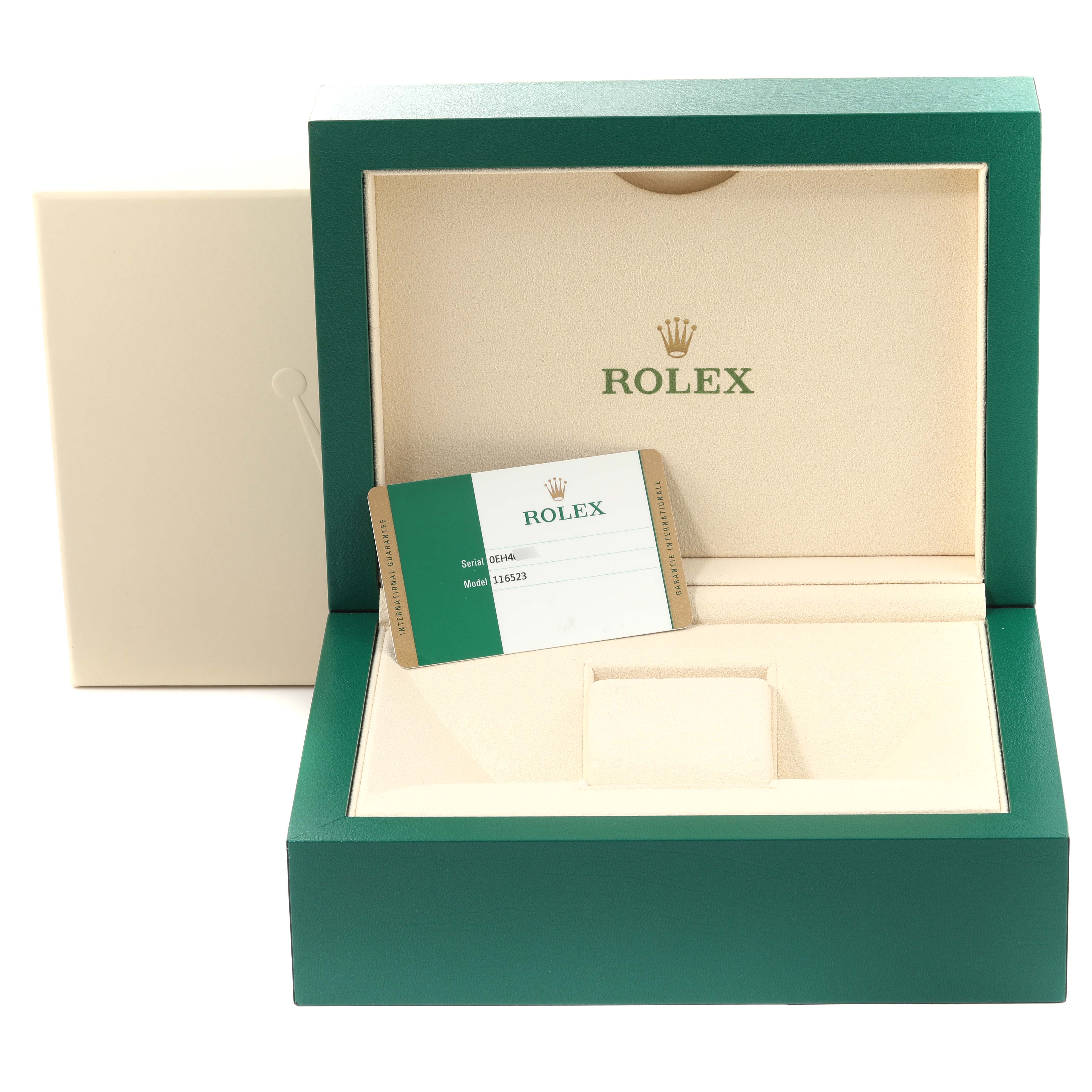 The image shows an open green Rolex box for the Daytona model with a Rolex warranty card inside.