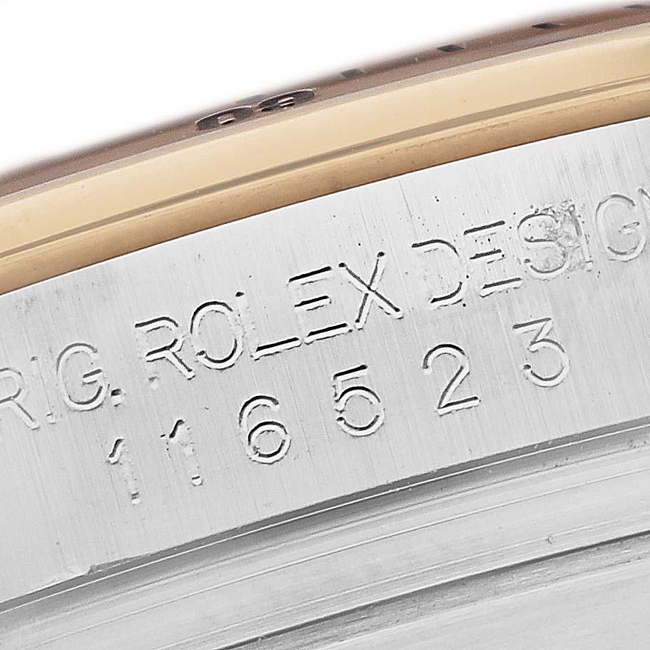 Close-up of the engraved serial number and Rolex branding on the side of a Daytona model by Rolex.