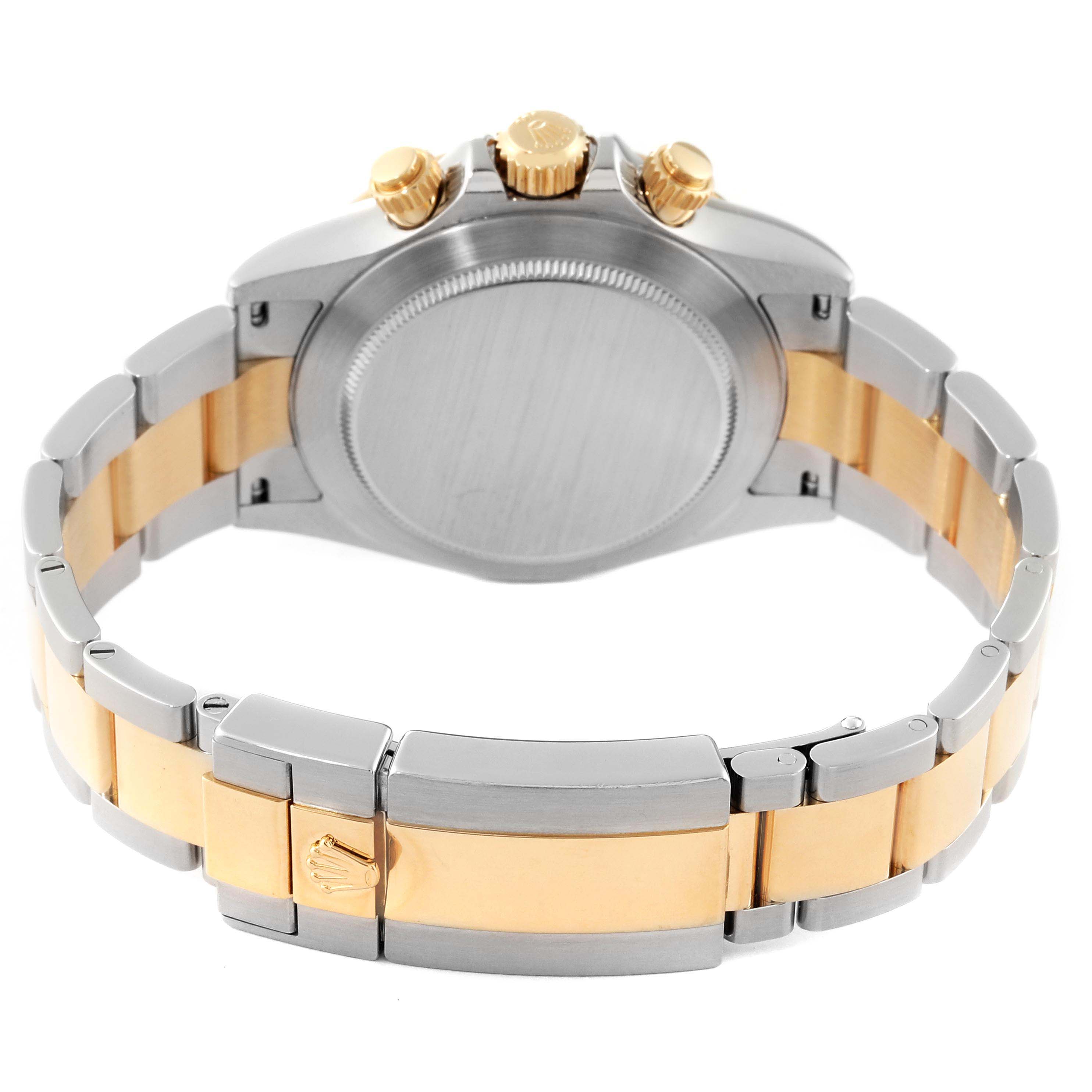This image shows the back of a Rolex Daytona 116523 Men's Steel and Gold (two tone) Silver Dial 116523 Men's Steel and Gold (two tone) Silver Dial watch, highlighting its clasp, bracelet, and crown.