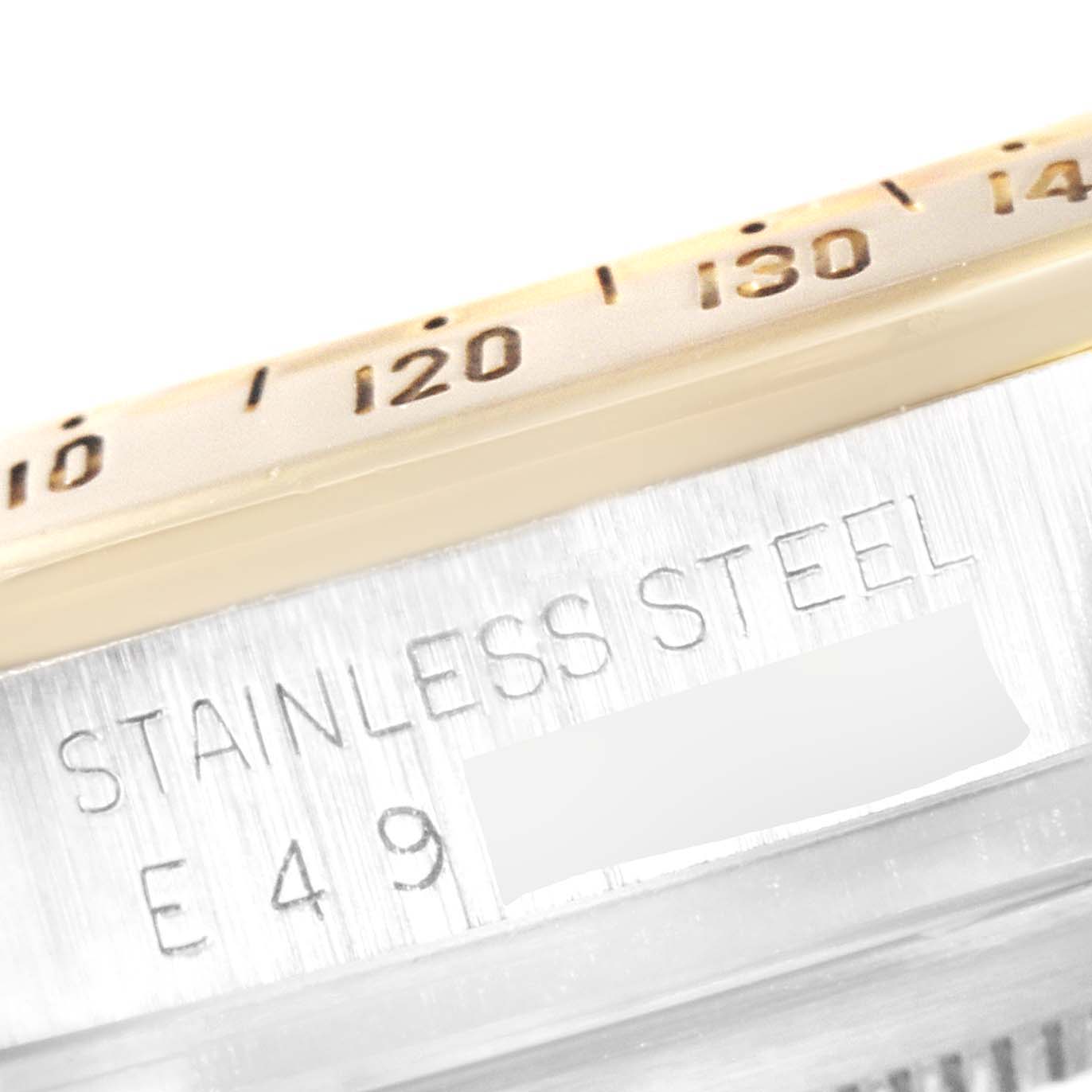 The image shows a close-up of the bezel and serial engravings on a Rolex Daytona 16523 Men's Steel and Gold (two tone) Champagne Dial 16523 Men's Steel and Gold (two tone) Champagne Dial stainless steel watch.