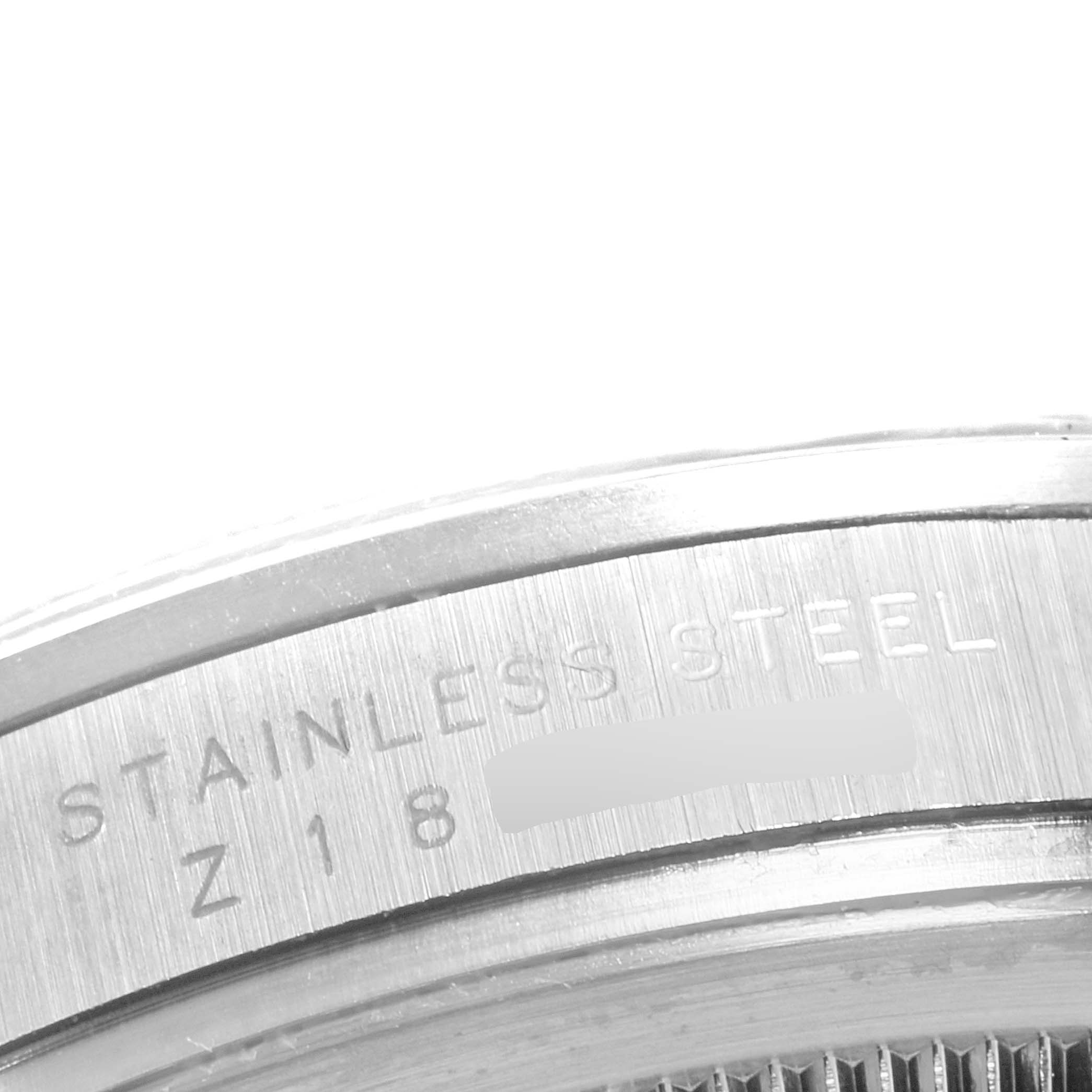 This image shows a close-up of the stainless steel case back of a Rolex Explorer 114270 Men
s Stainless Steel Black Dial 114270 Men
s Stainless Steel Black Dial watch.