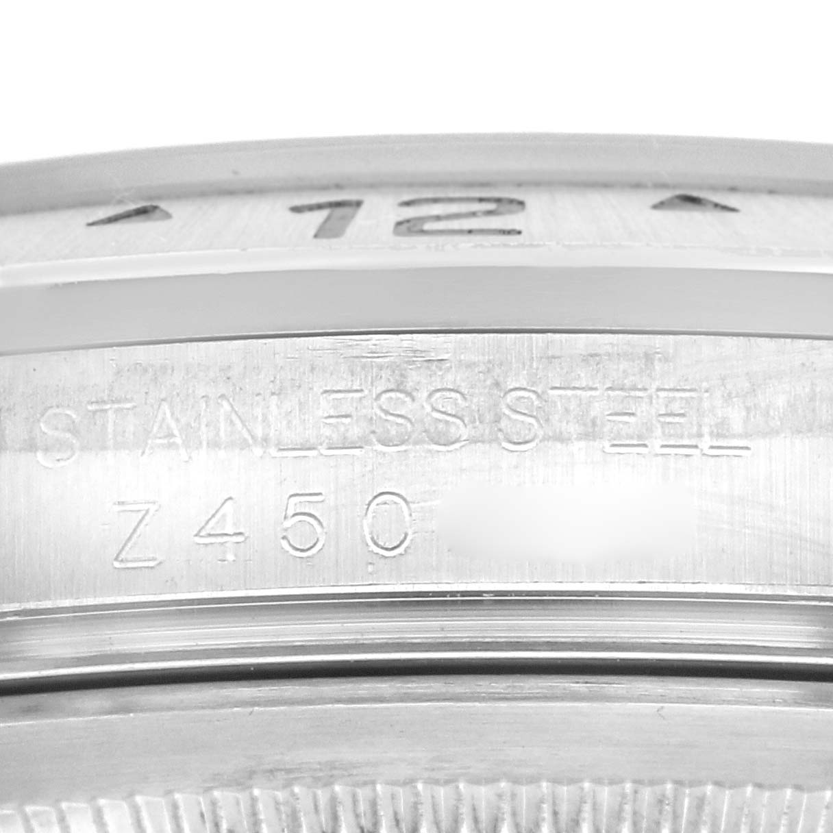 This is a close-up view of the Rolex Explorer 16570 Men
s Stainless Steel Black Dial 16570 Men
s Stainless Steel Black Dial model showing the stainless steel marking and some partial numerals on the bezel.