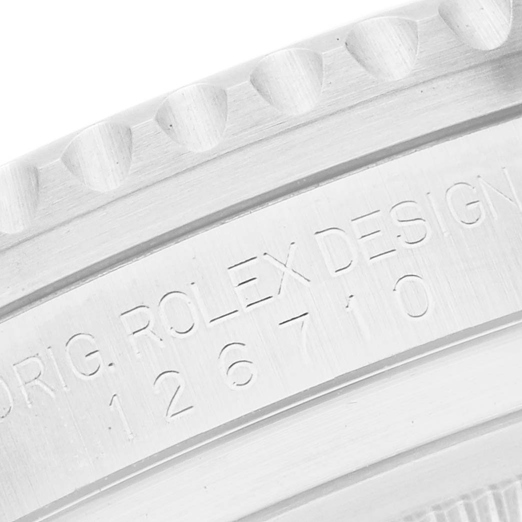 The image shows a close-up of the side of a Rolex GMT-Master 126710 Men
s Stainless Steel Black Dial, featuring the model number and part of the bezel.