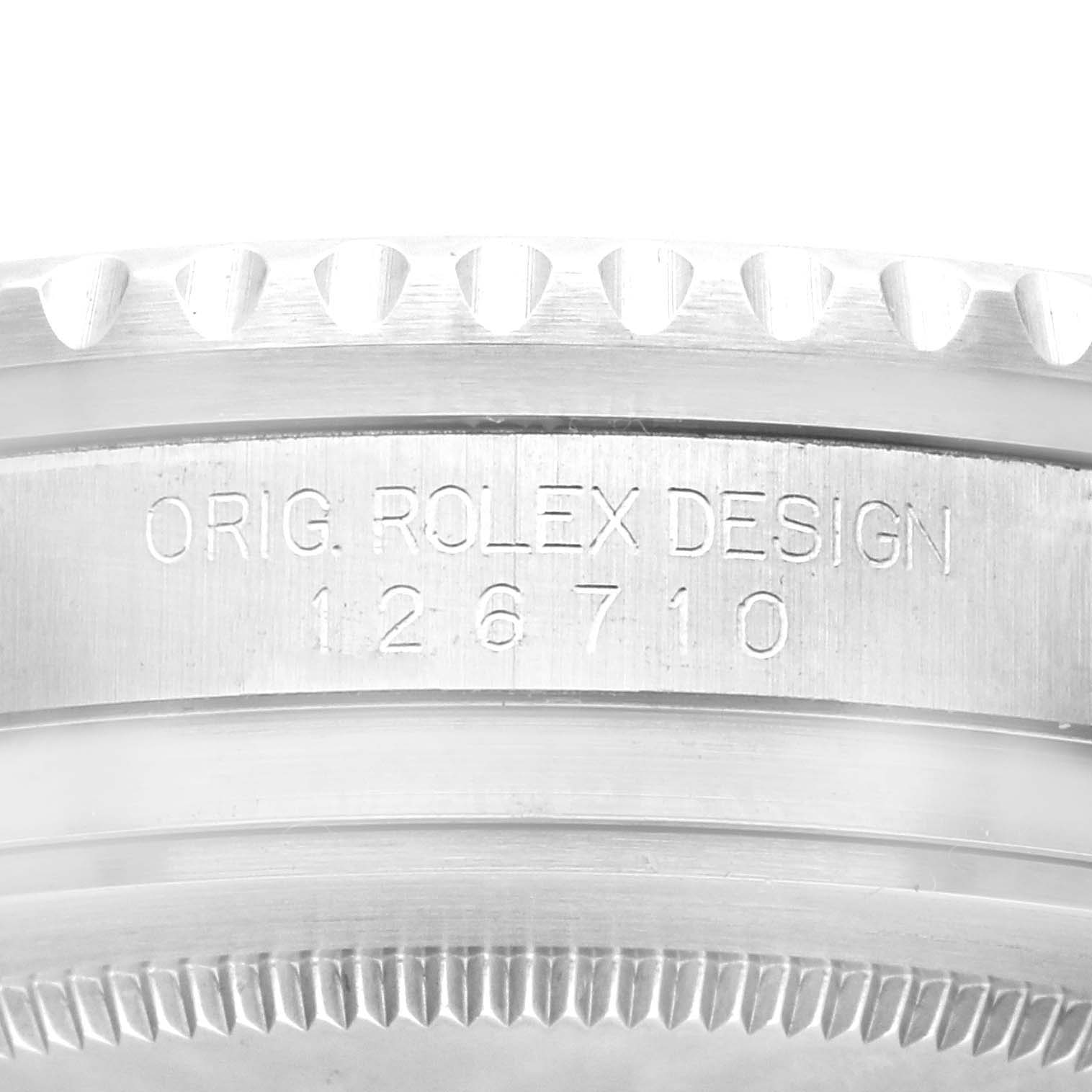 The image shows a close-up of a part of the Rolex GMT-Master 126710BLRO Men's Stainless Steel Black Dial 126710BLRO Men's Stainless Steel Black Dial, focusing on the bezel and case with the engraved model number 126710.